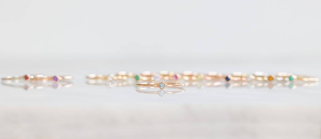Birthstone Stacker Rings in a line with Aquamarine Stacker in the Forefront