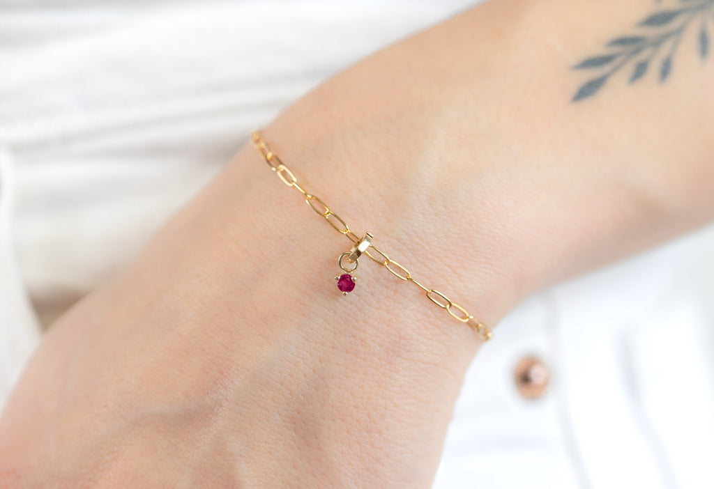 10k Yellow Gold Ruby Birthstone Charm on Charm Bracelet on Model