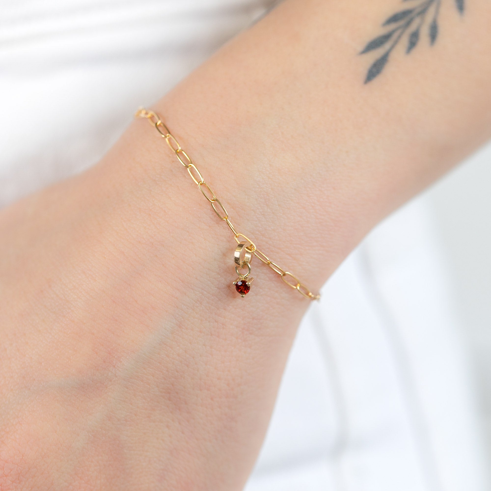 buy:the-drawn-cable-chain-charm-bracelet-10k-yellow-gold,the-garnet-birthstone-charm-10k-yellow-gold
