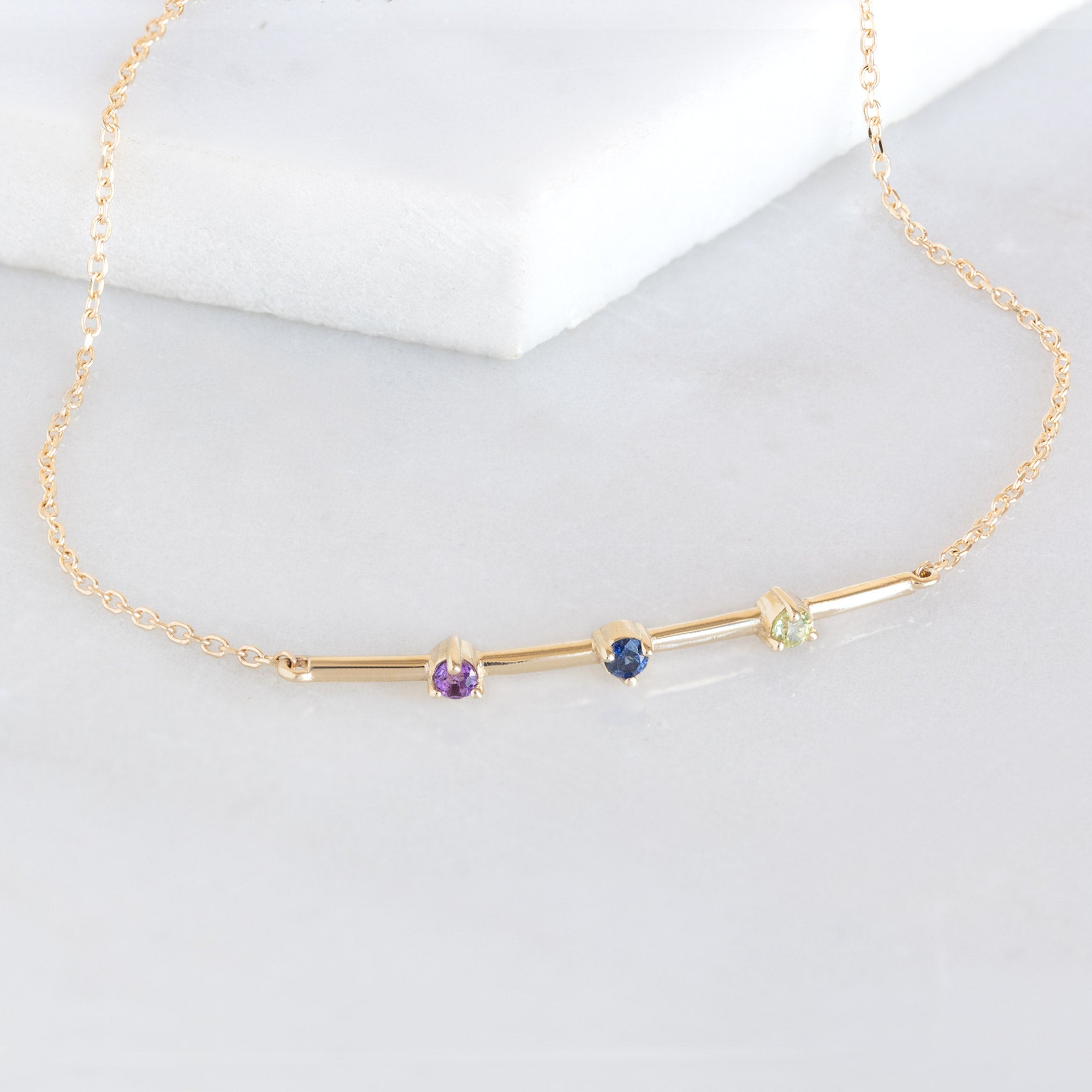 The Custom Multi-Birthstone Bracelet 3 Stone Option on White Marble