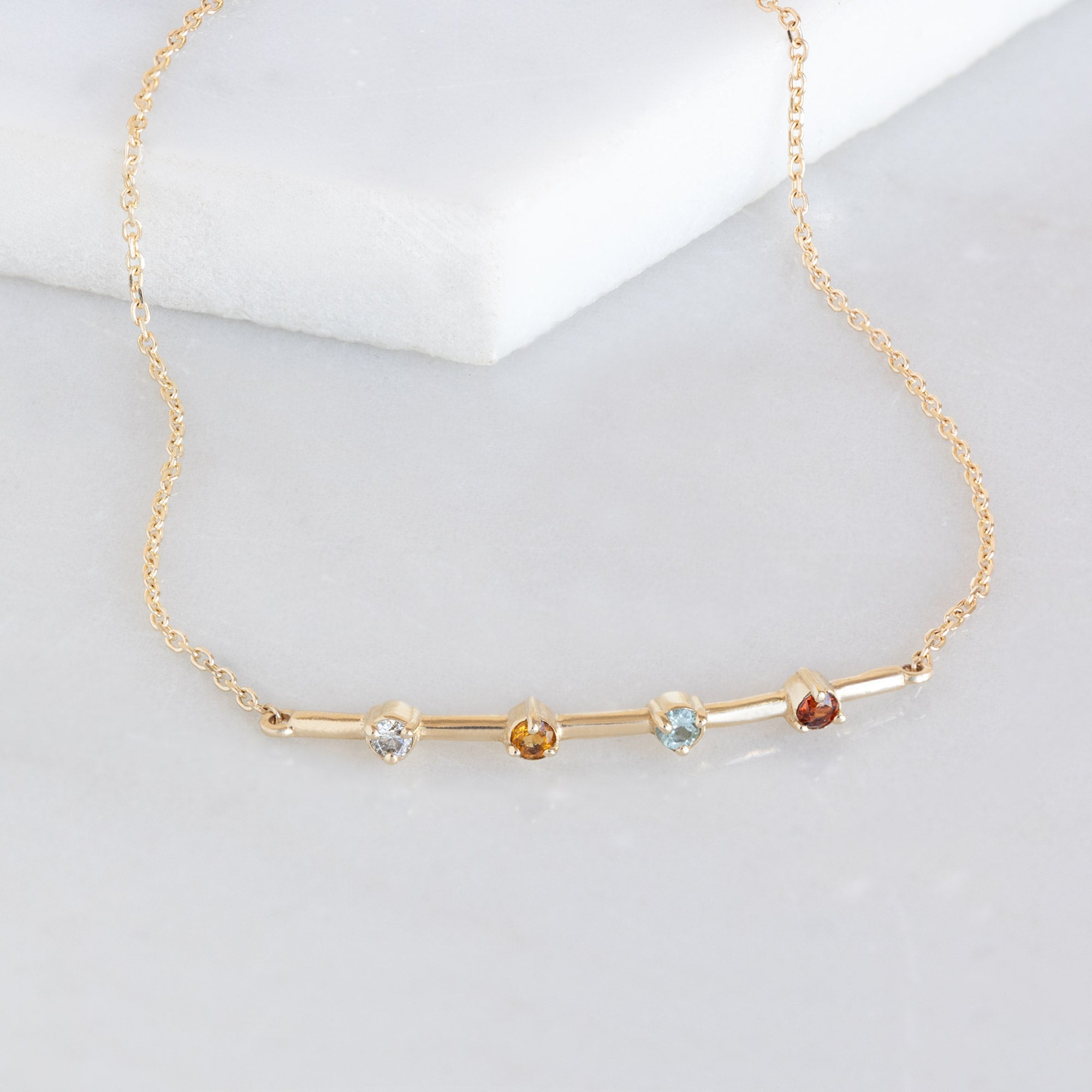 The Custom Multi-Birthstone Bracelet 4 Stone Option on White Marble