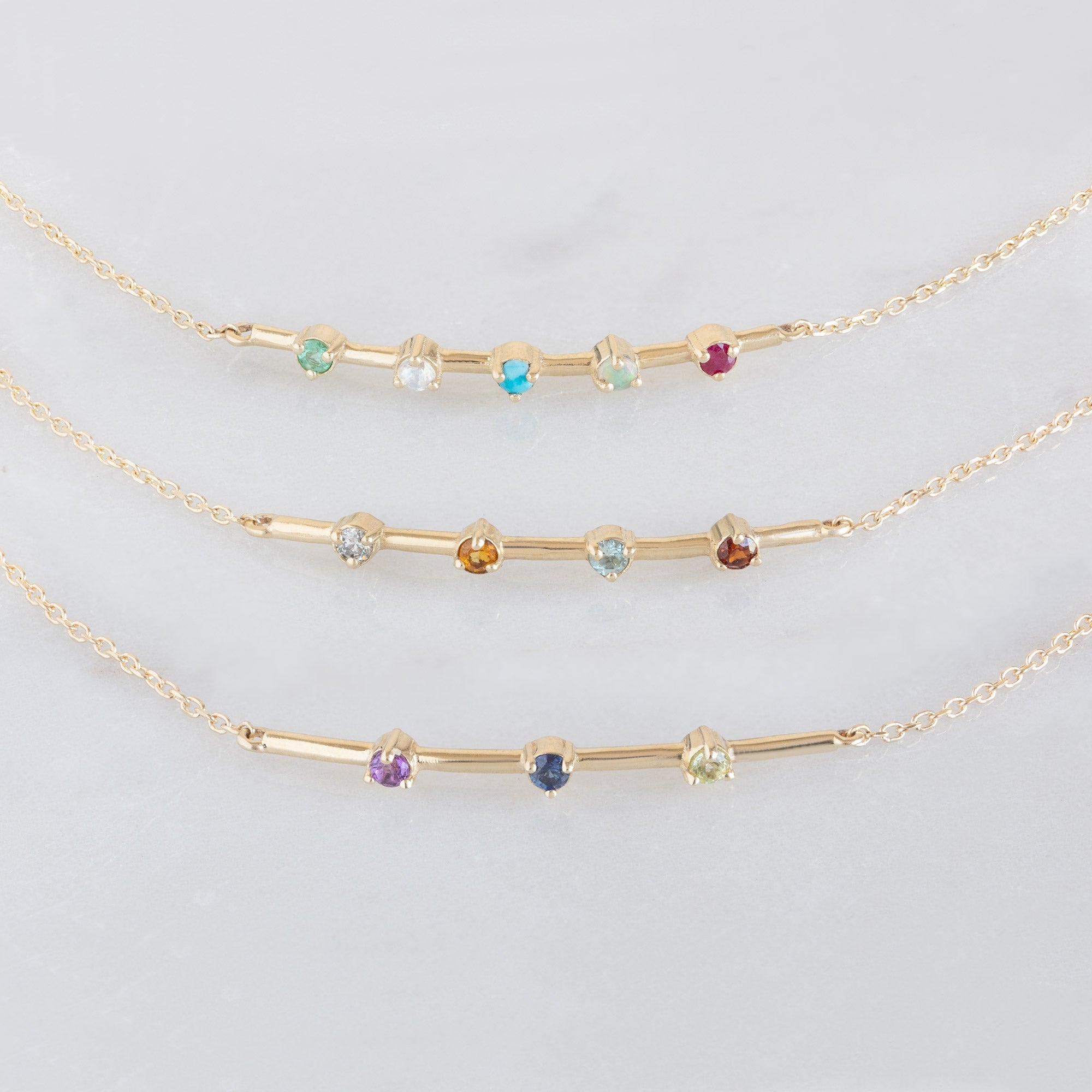 The Custom Multi-Birthstone Bracelets on White Marble