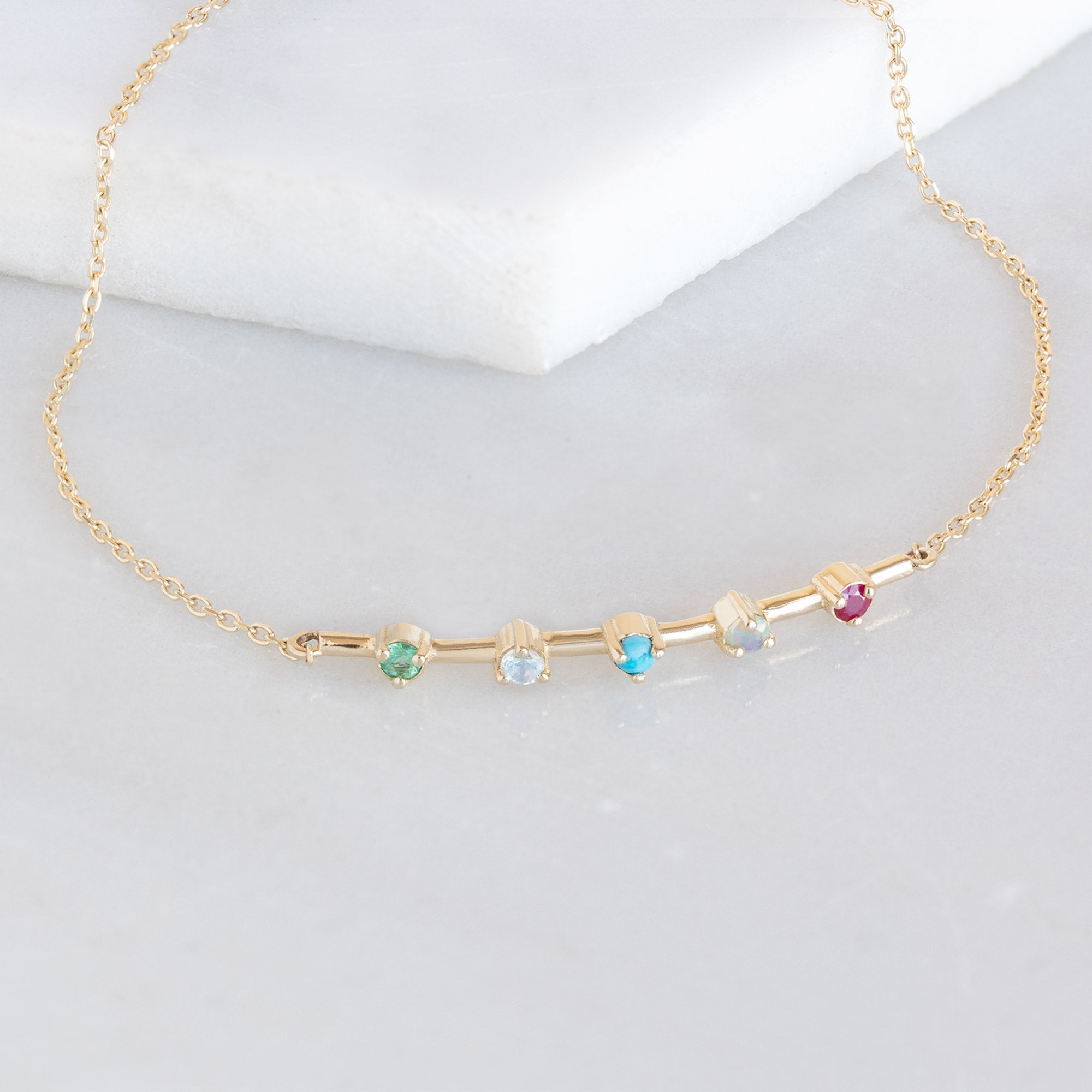 The Custom Multi-Birthstone Bracelet 5 Stone Option on White Marble