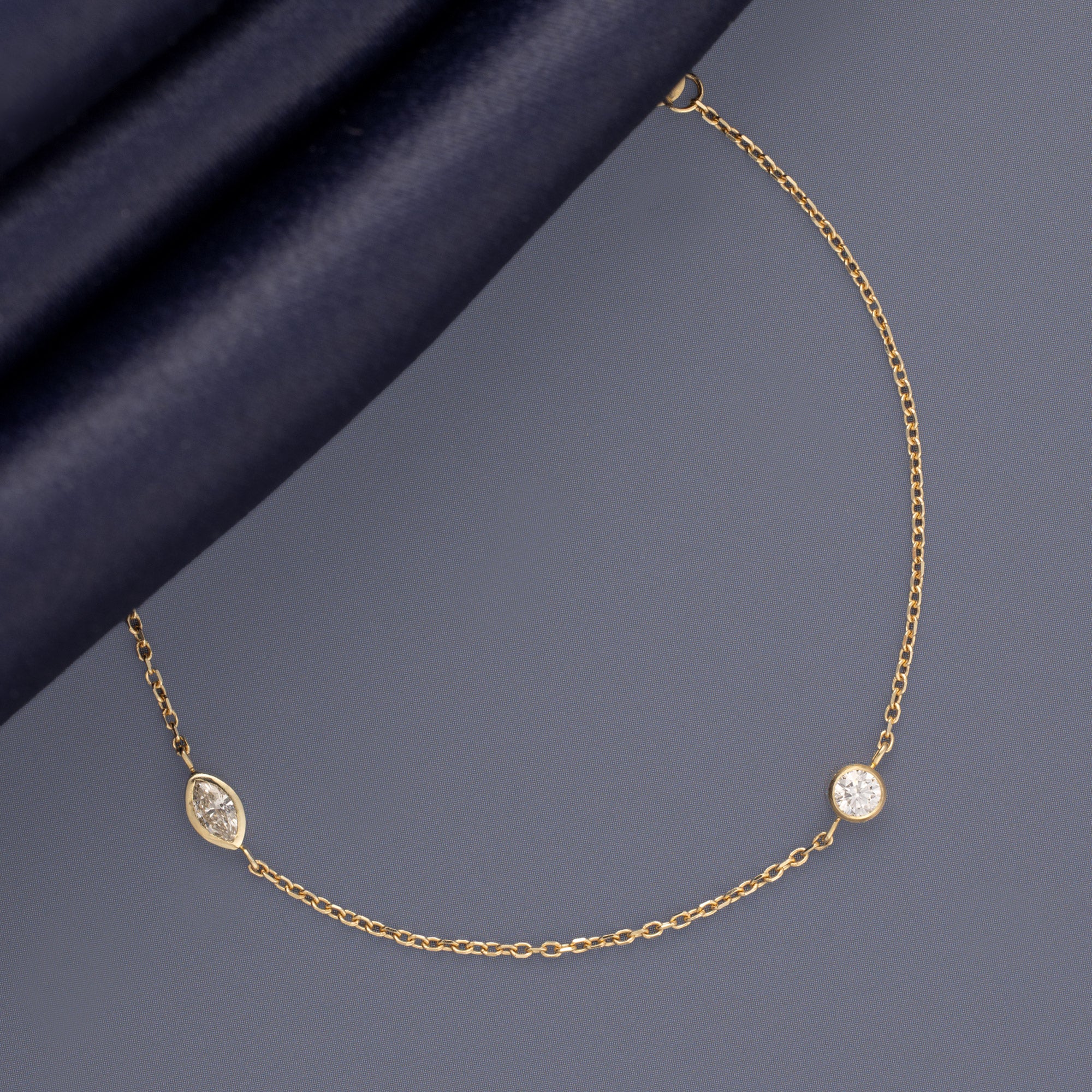 Marquis Diamond Chain Bracelet in 10K Yellow Gold on Muted Blue Background