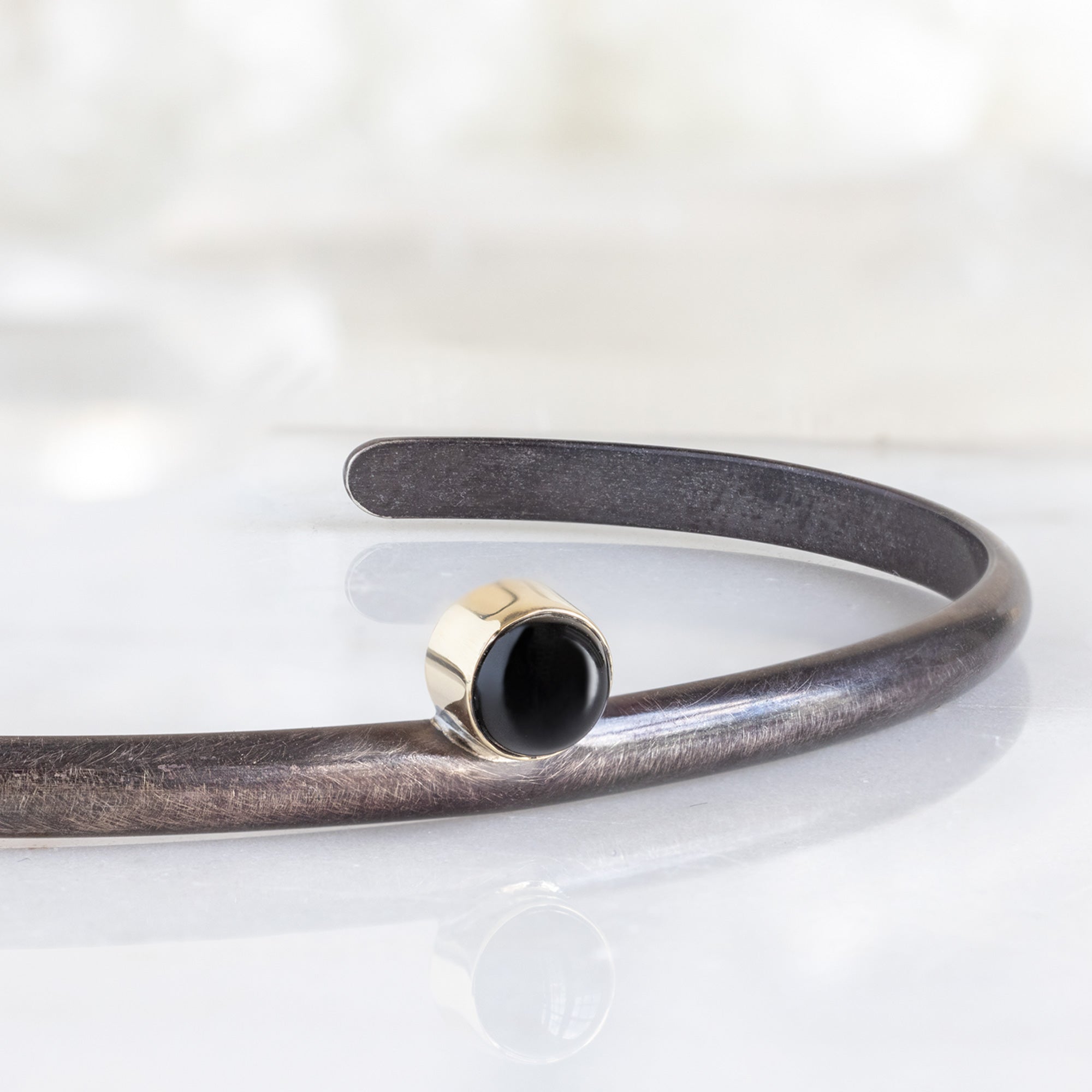 Close Up of The Onyx Cuff Bracelet in Oxidized Sterling Silver in White Marble