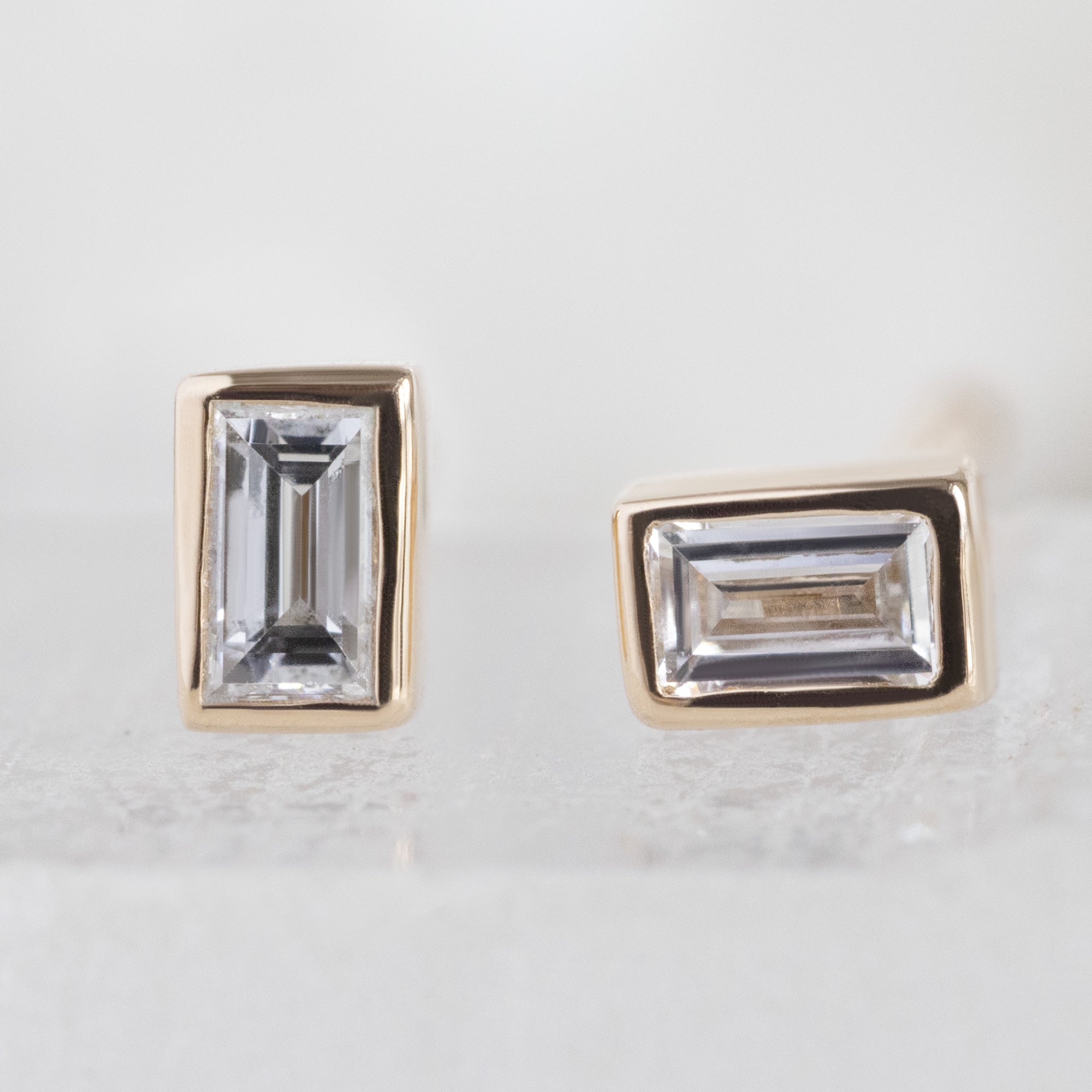 The White Diamond Baguette Stud Earrings in 14k Yellow Gold on White Crystal