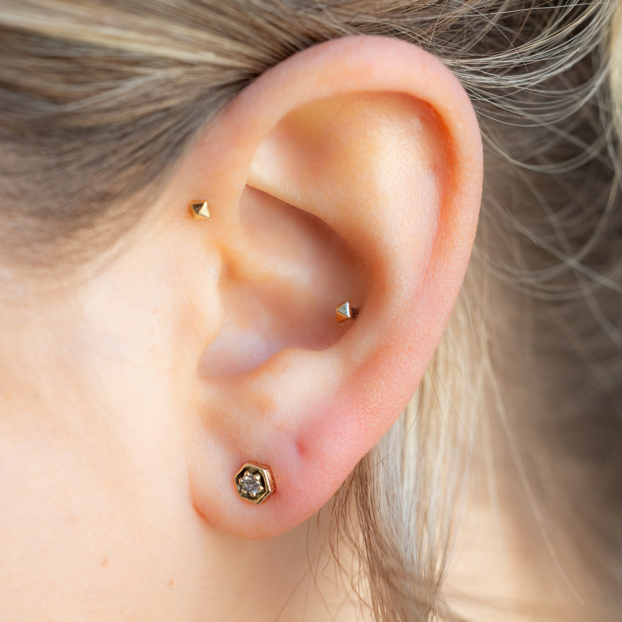 The Galaxy Salt and Pepper Diamond Hexagon Stud Earrings in 14K Yellow Gold on Model