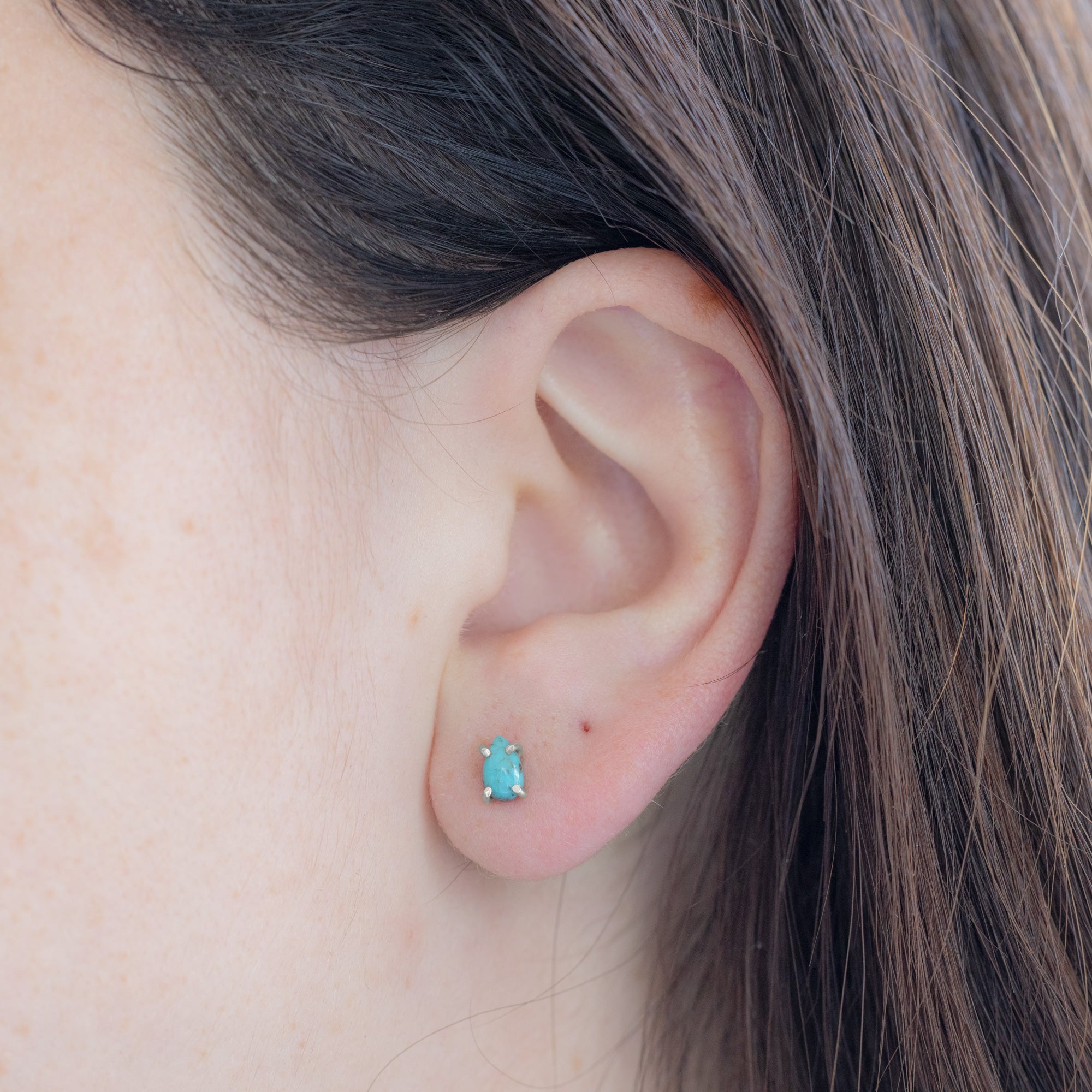 The Turquoise Stud Earrings in Sterling Silver on model