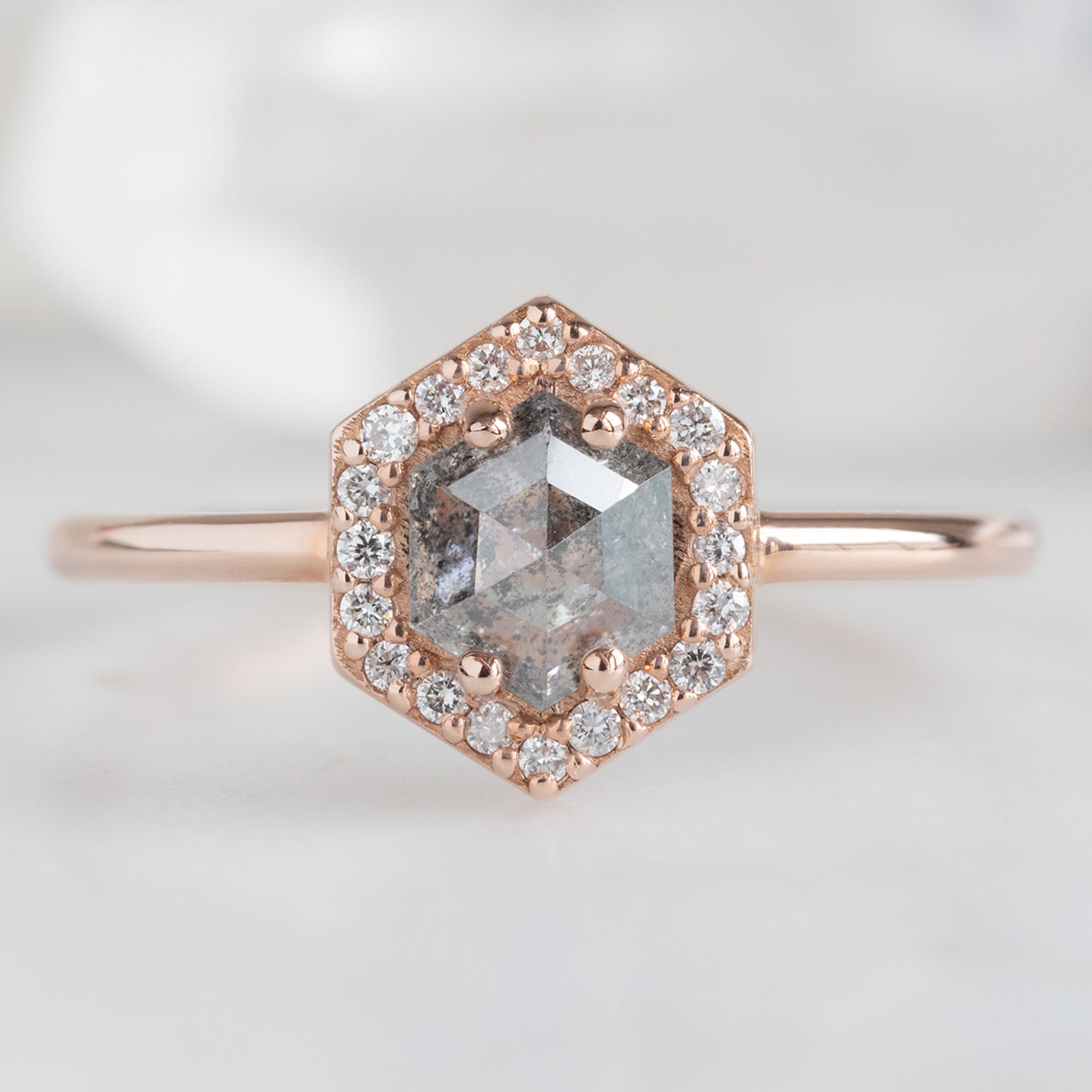 The Dahlia Ring with a 0.89ct Hexagon Salt and Pepper Diamond in 14K Rose Gold on White Background
