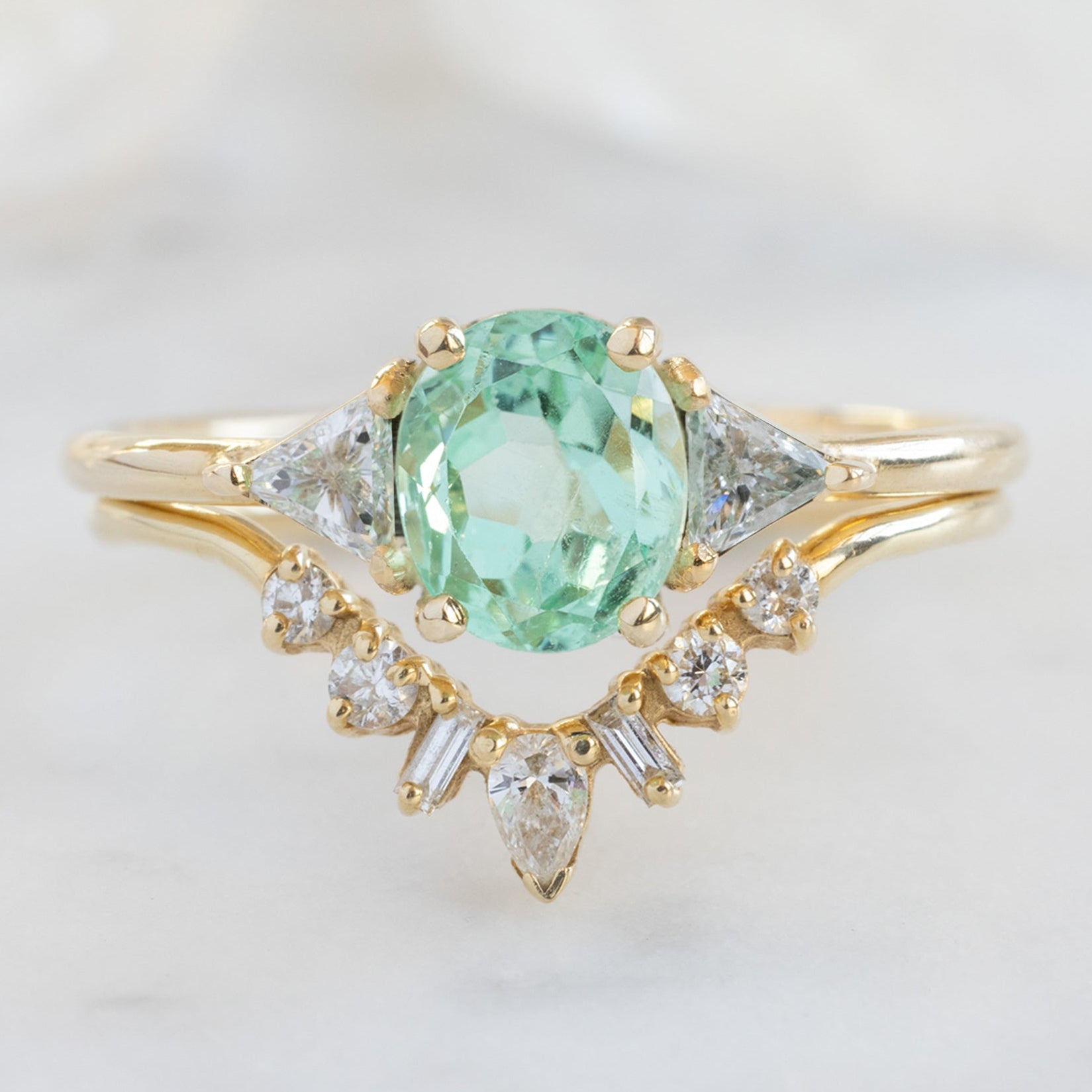 The Jade Ring with a 0.89ct Oval Emerald in 14K Yellow Gold Stacked with the Geometric White Diamond Sunburst Stacking Band