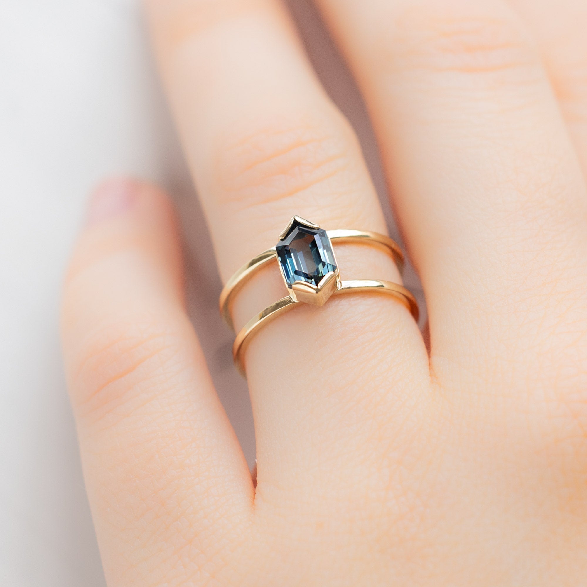 The Poppy Ring with a 1.24ct Hexagon Blue Sapphire in 14K Yellow Gold on Model