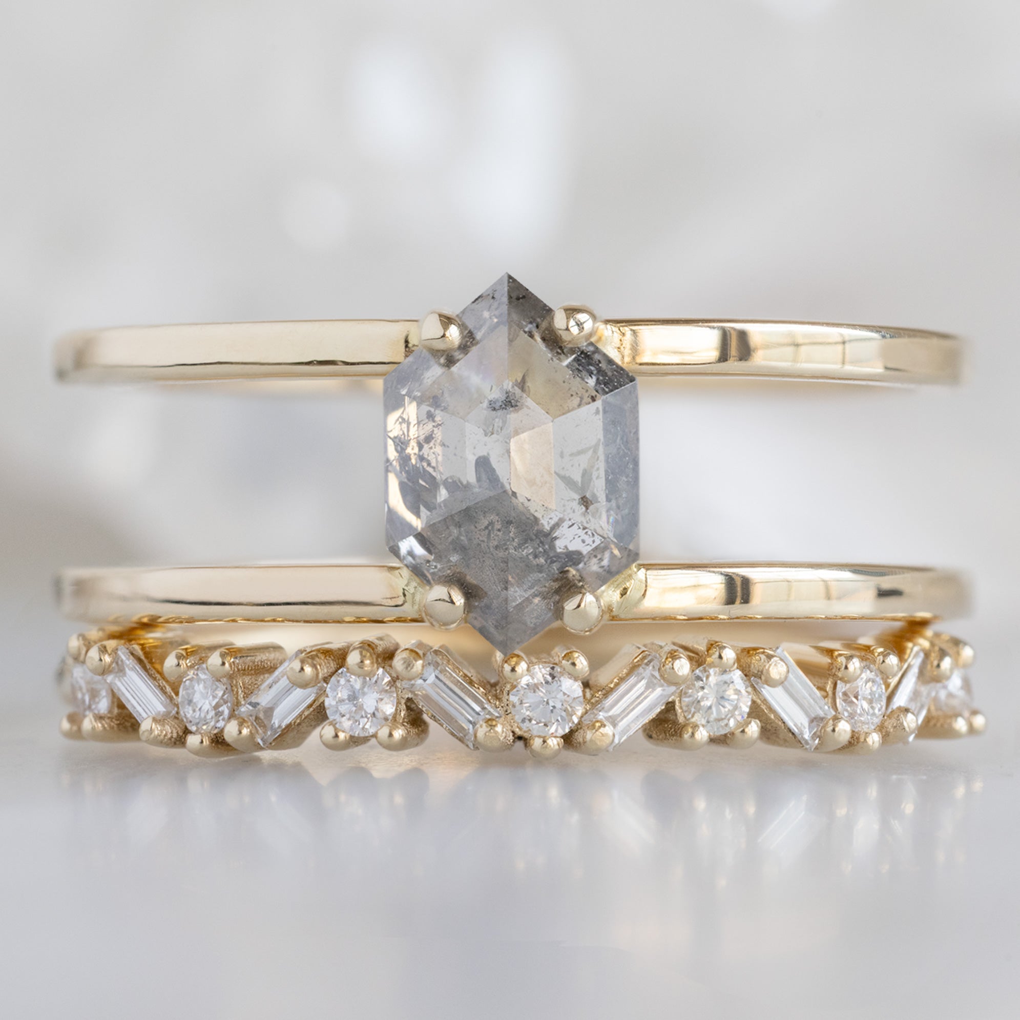 The Poppy Ring with a 1.02ct Hexagon Salt and Pepper Diamond in 14K Yellow Gold Stacked with the Diamond Baguette Stacking Ring