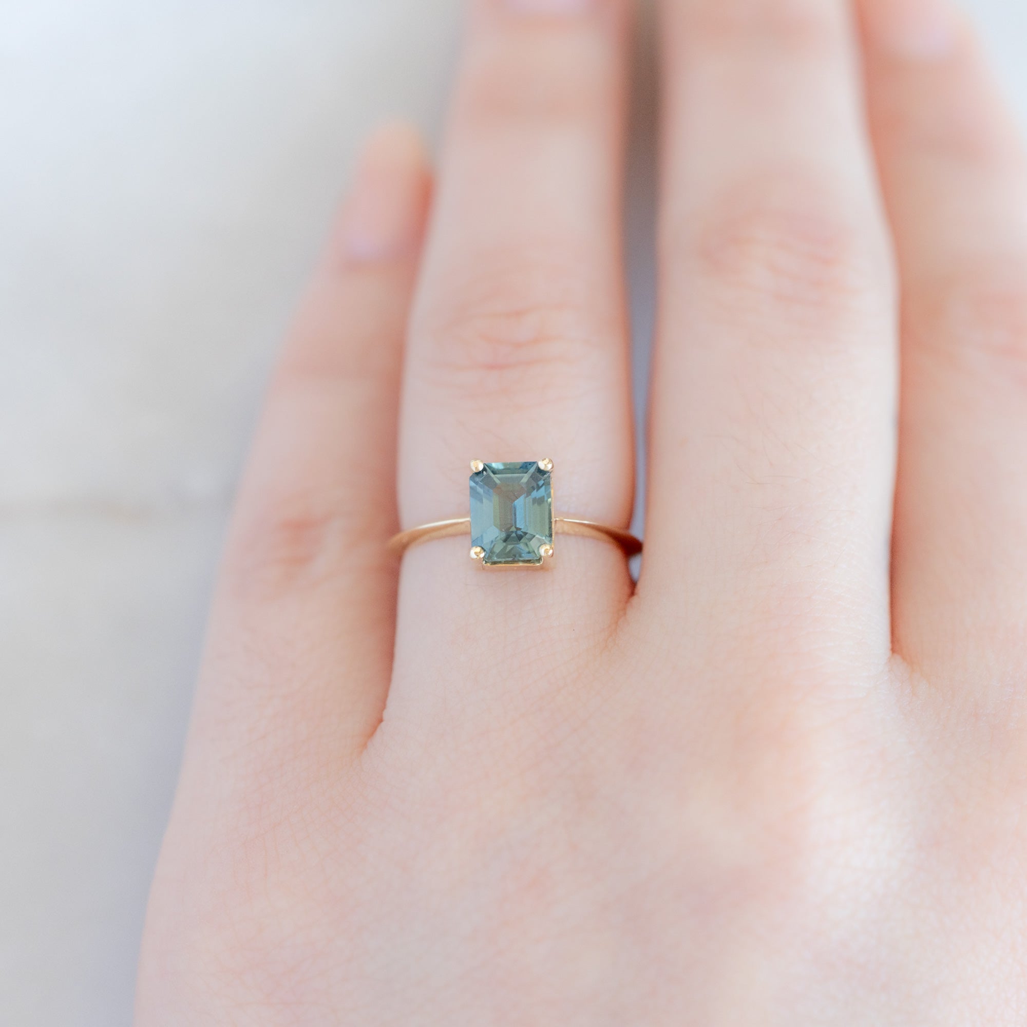 The Bryn Ring with a 1.78ct Emerald Cut Sapphire in 14K Yellow Gold on Model