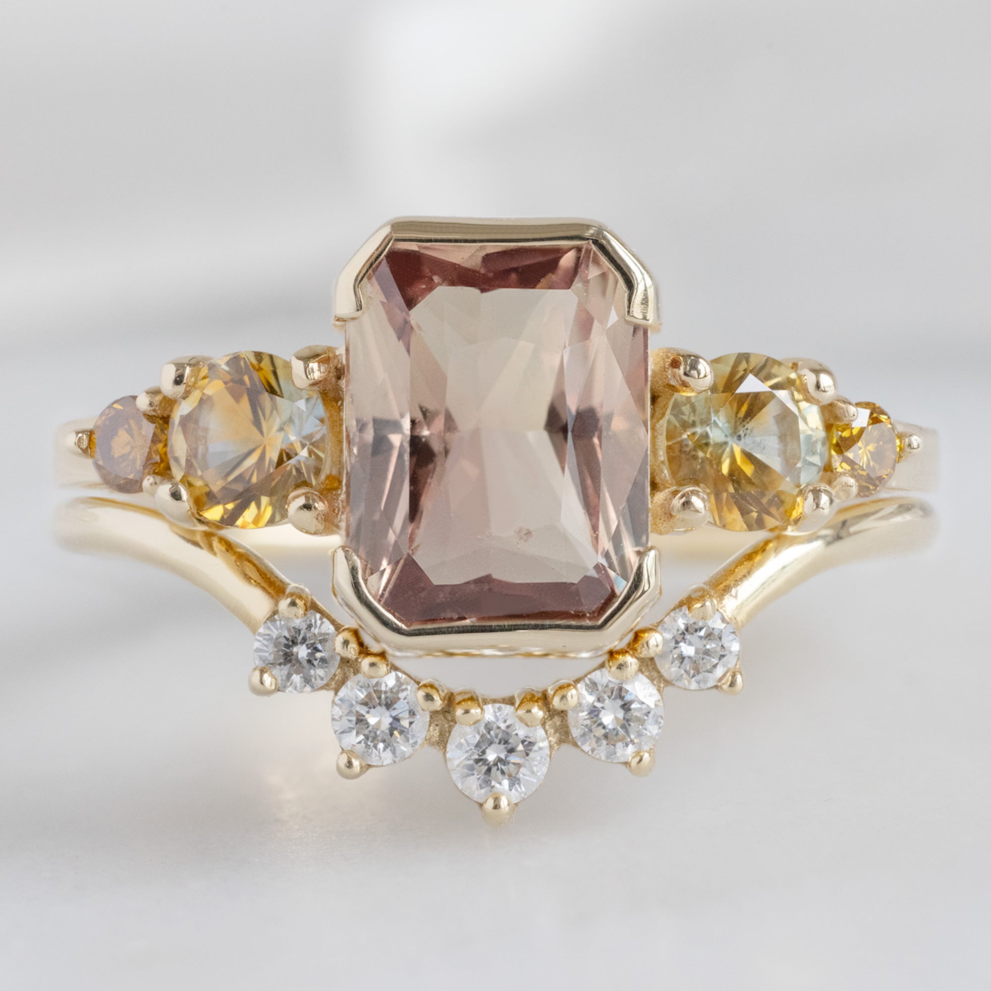 buy:the-watercolor-ring-2-04ct-emerald-cut-colored-sapphire-in-14k-yellow-gold,round-white-diamond-sunburst-stacking-band-14k-or-18k-yellow-gold