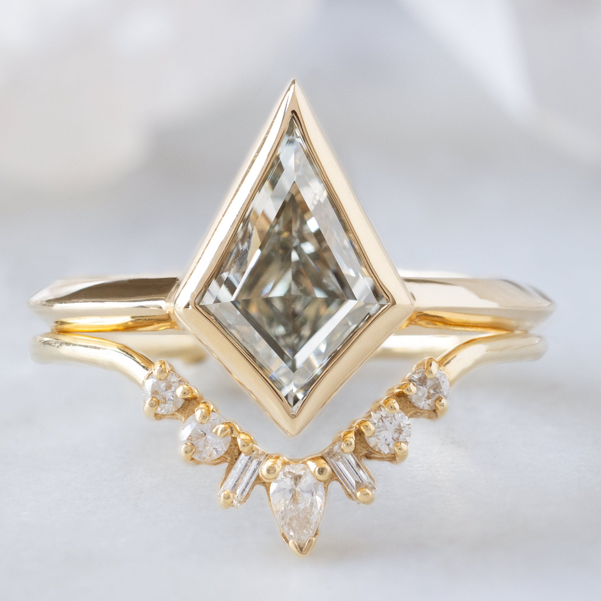 he Hazel Ring with a 2.00ct Lab Grown White Kite Diamond in 14K Yellow Gold Stacked with the Geometric White Diamond Sunburst Stacking Band