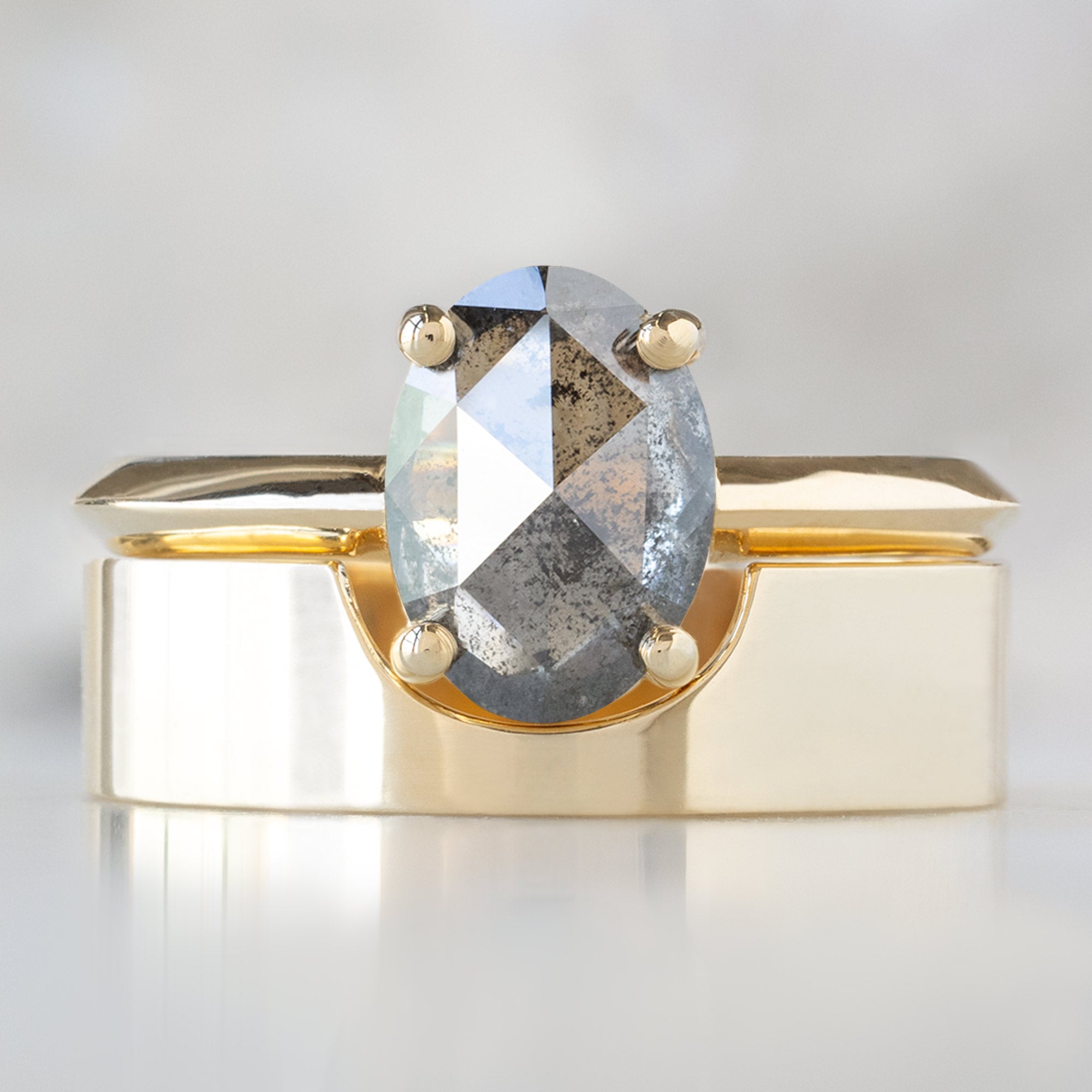 The Bryn Ring with a 1.41ct Oval Salt and Pepper Diamond in 14K Yellow Gold Stacked with the Gold Cut-Out Stacking Band