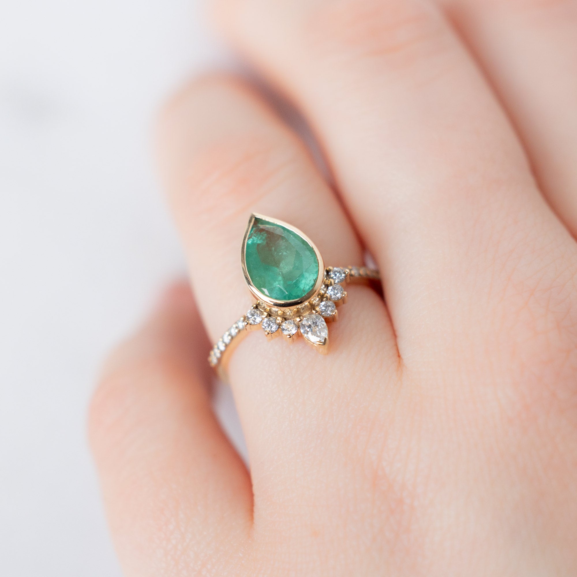 The Aster Ring with a 2.12ct Pear Emerald in 14K Yellow Gold on Model