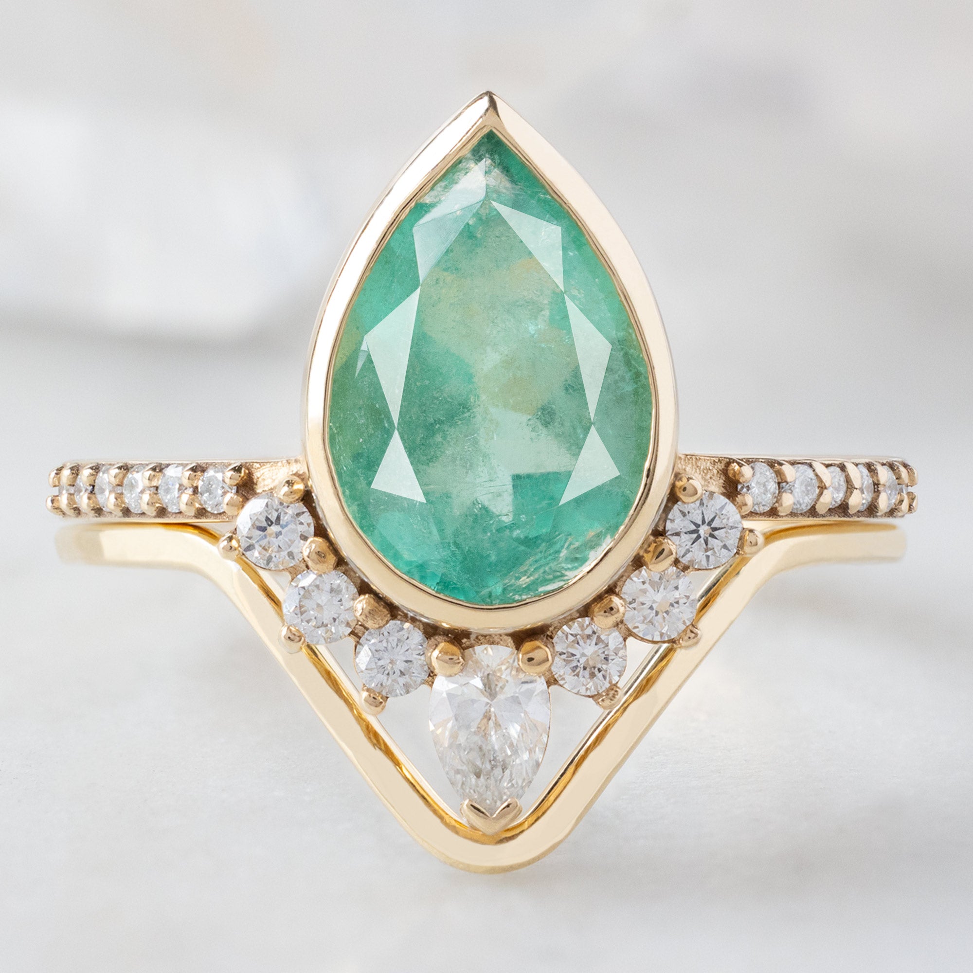 The Aster Ring with a 2.12ct Pear Emerald in 14K Yellow Gold Stacked with the Gold Peak Stacking Band