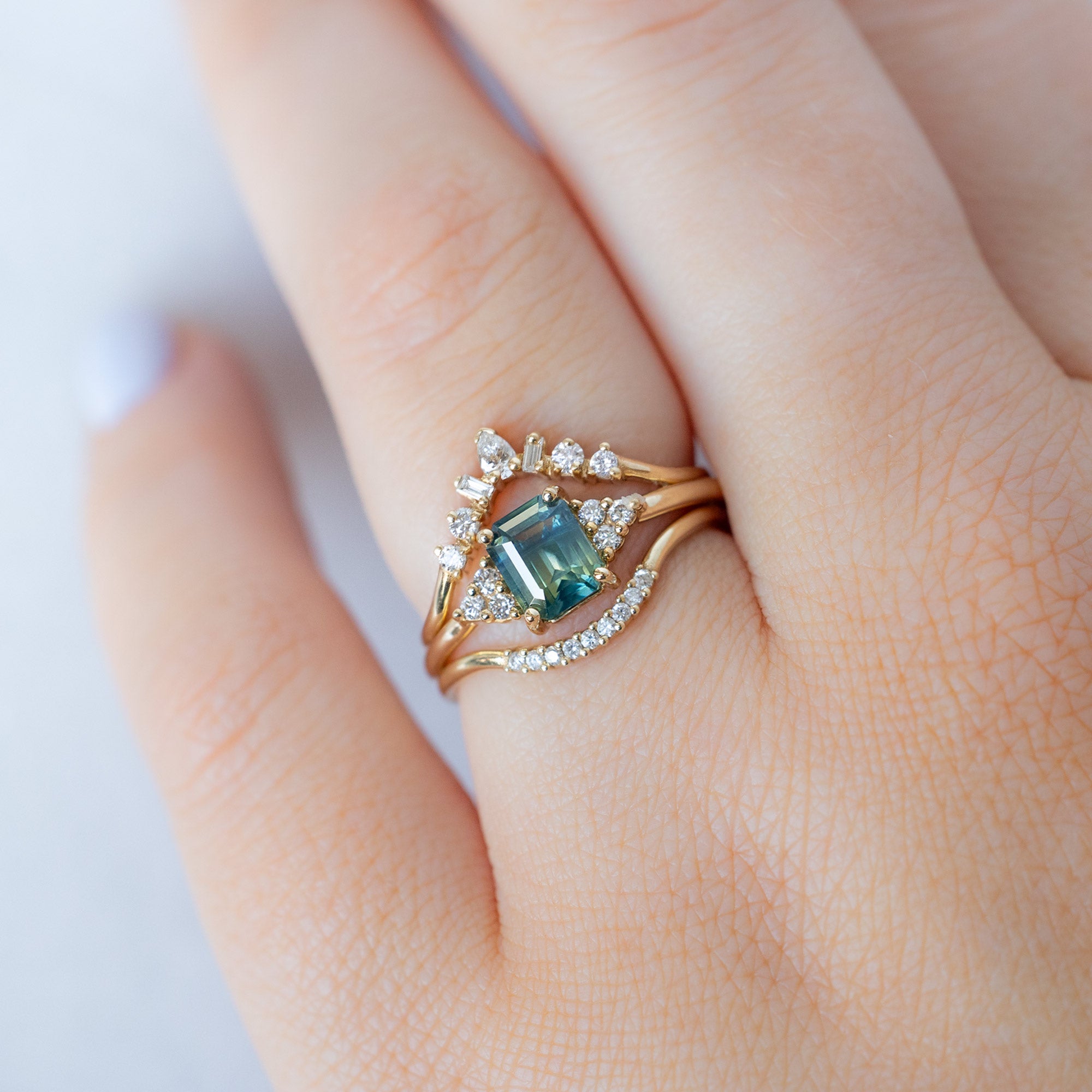 buy:geometric-white-diamond-sunburst-stacking-band-14k-or-18k-yellow-gold,the-ivy-ring-1-06ct-emerald-cut-teal-sapphire-in-14k-yellow-gold,white-diamond-pave-arc-stacking-band-14k-or-18k-yellow-gold