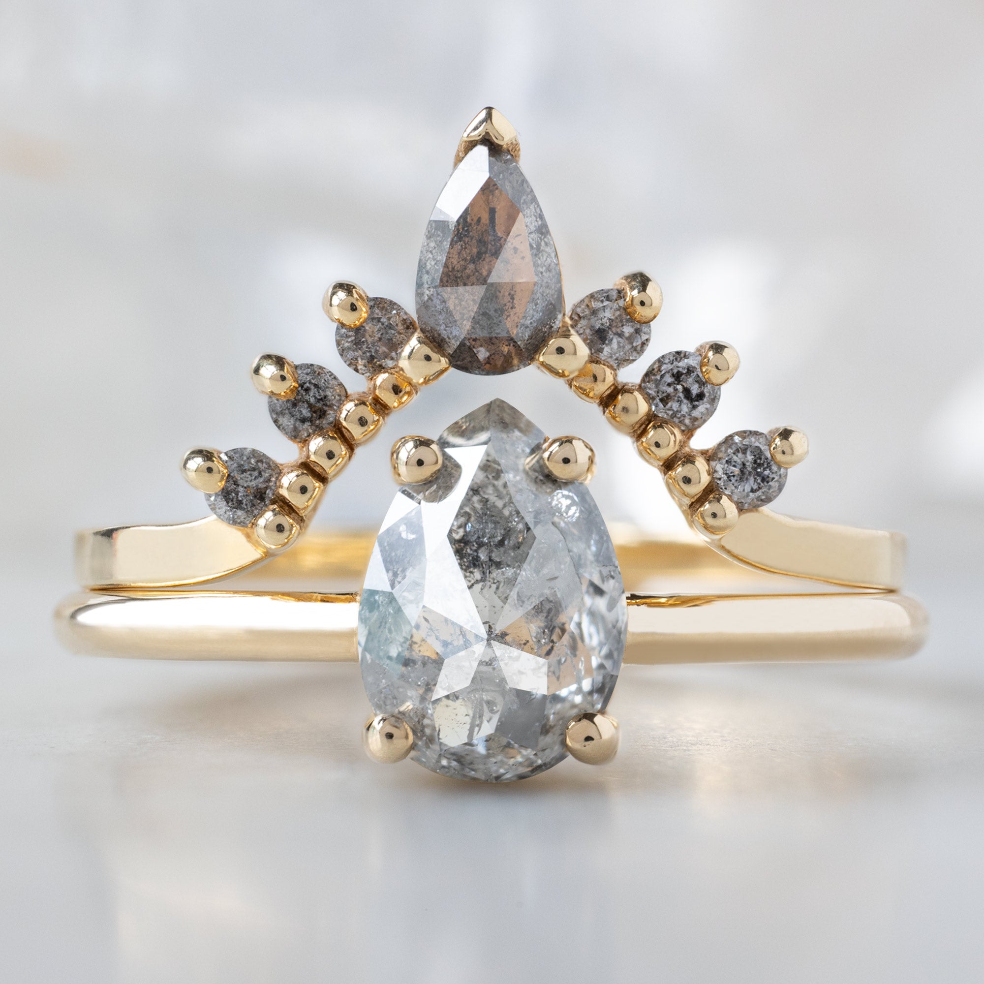 The Bryn Ring with a 1.10ct Pear Salt and Pepper Diamond in 14K Yellow Gold Stacked with the Salt and Pepper Diamond Sunburst Stacking Band