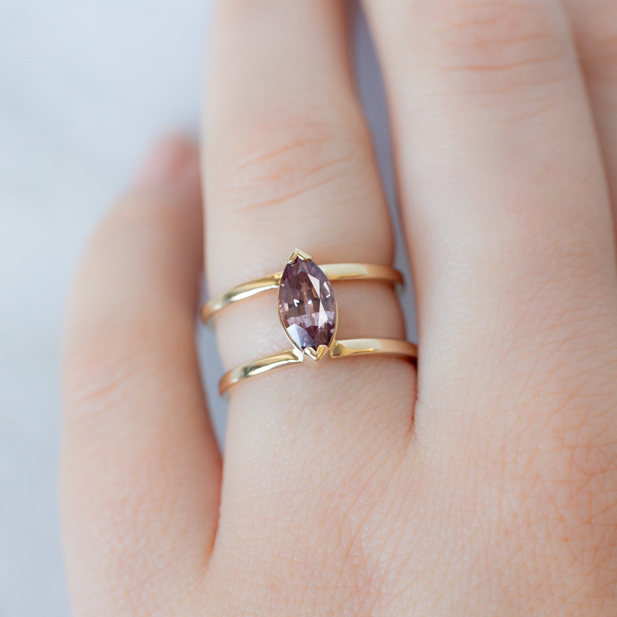 The Poppy Ring with a 1.38ct Marquise Mauve Garnet in 14K Yellow Gold on Model