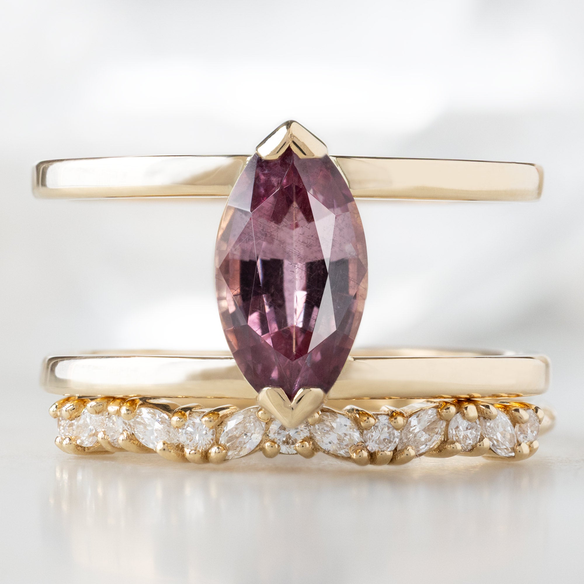 The Poppy Ring with a 1.38ct Marquise Mauve Garnet in 14K Yellow Gold Stacked with the Marquise Confetti Wedding Band