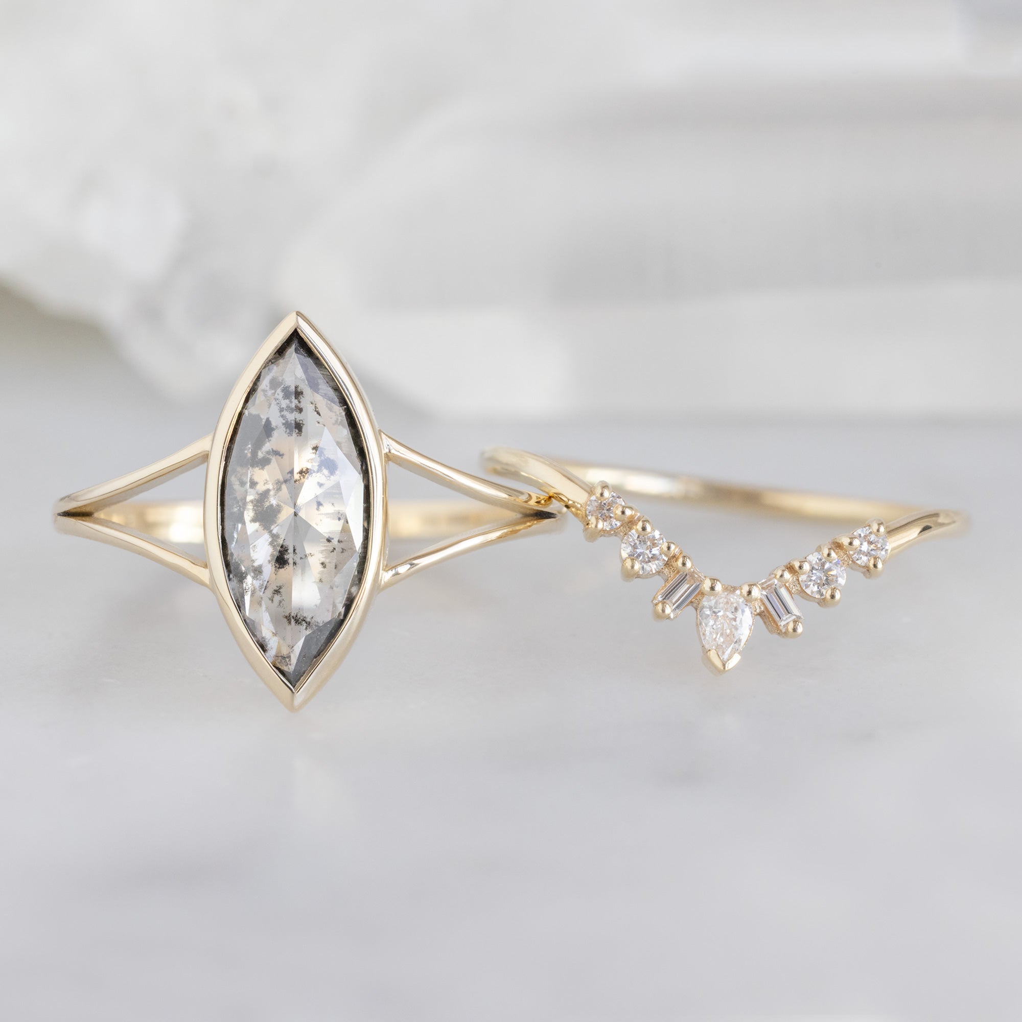 The Magnolia Ring with a 1.65ct Lab Grown Salt and Pepper Diamond in 14K Yellow Gold Stacked with the White Diamond Geometric Sunburst Stacking Band