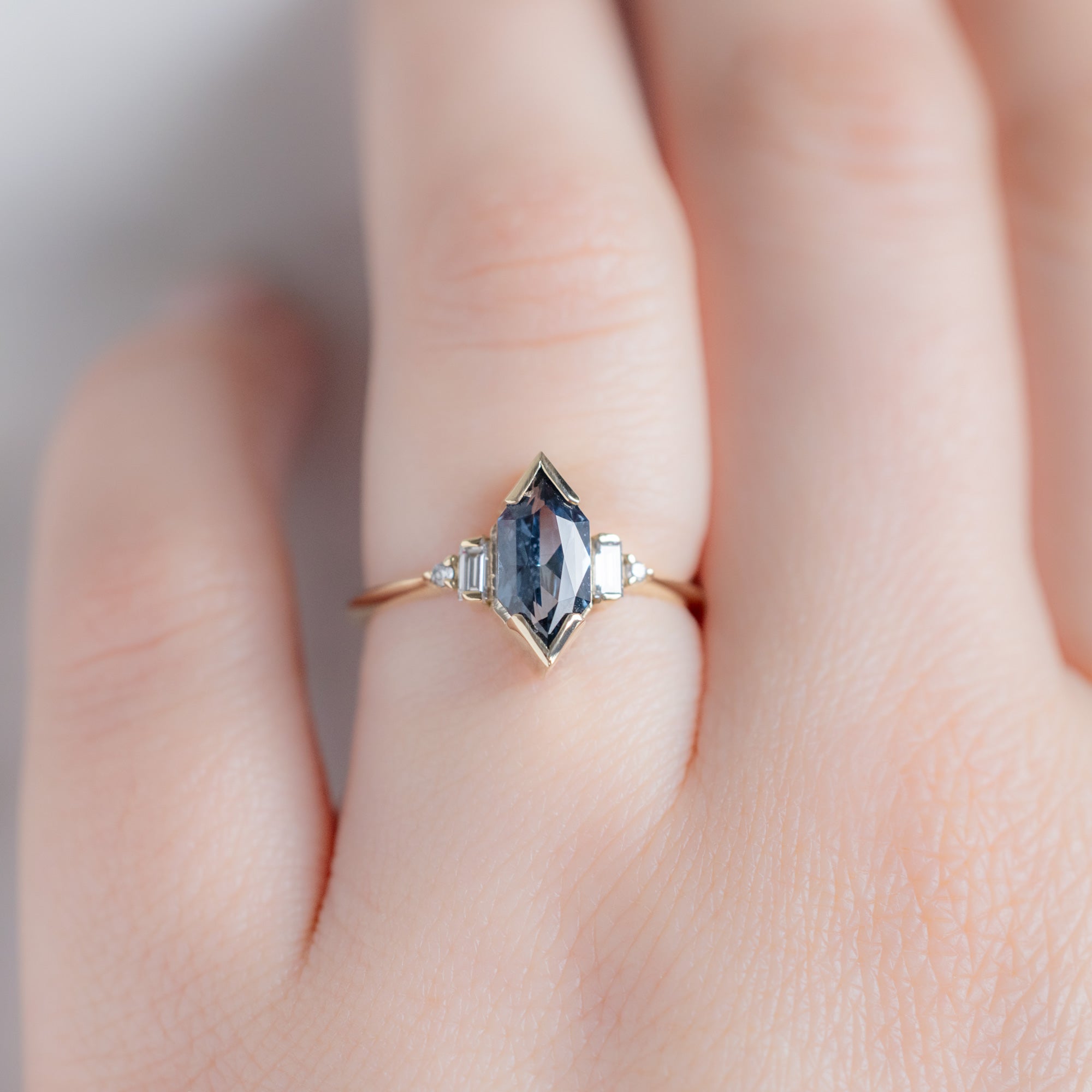The Primrose Ring with a 1.54ct Blue Sapphire Hexagon in 14K Yellow Gold on Model