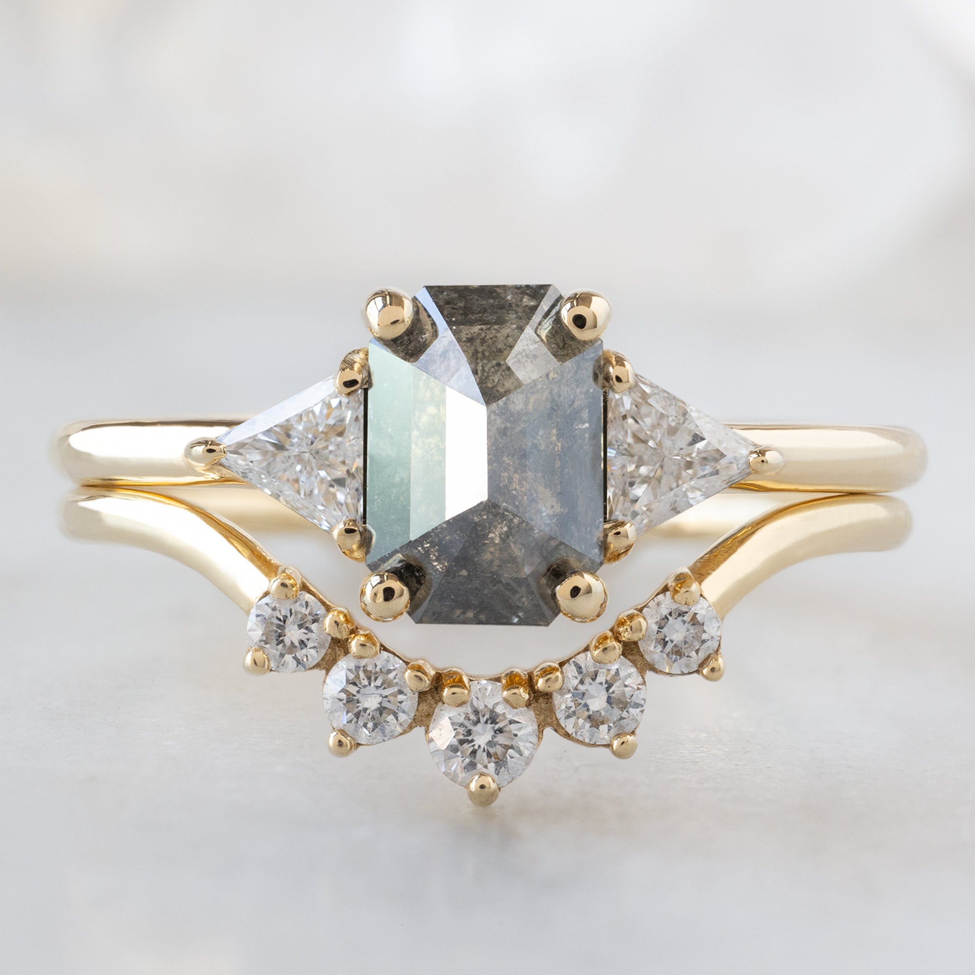 The Jade Ring with a 0.88ct Emerald Cut Salt and Pepper Diamond in 14K Yellow Gold Stacked with the Round White Diamond Sunburst Stacking Band