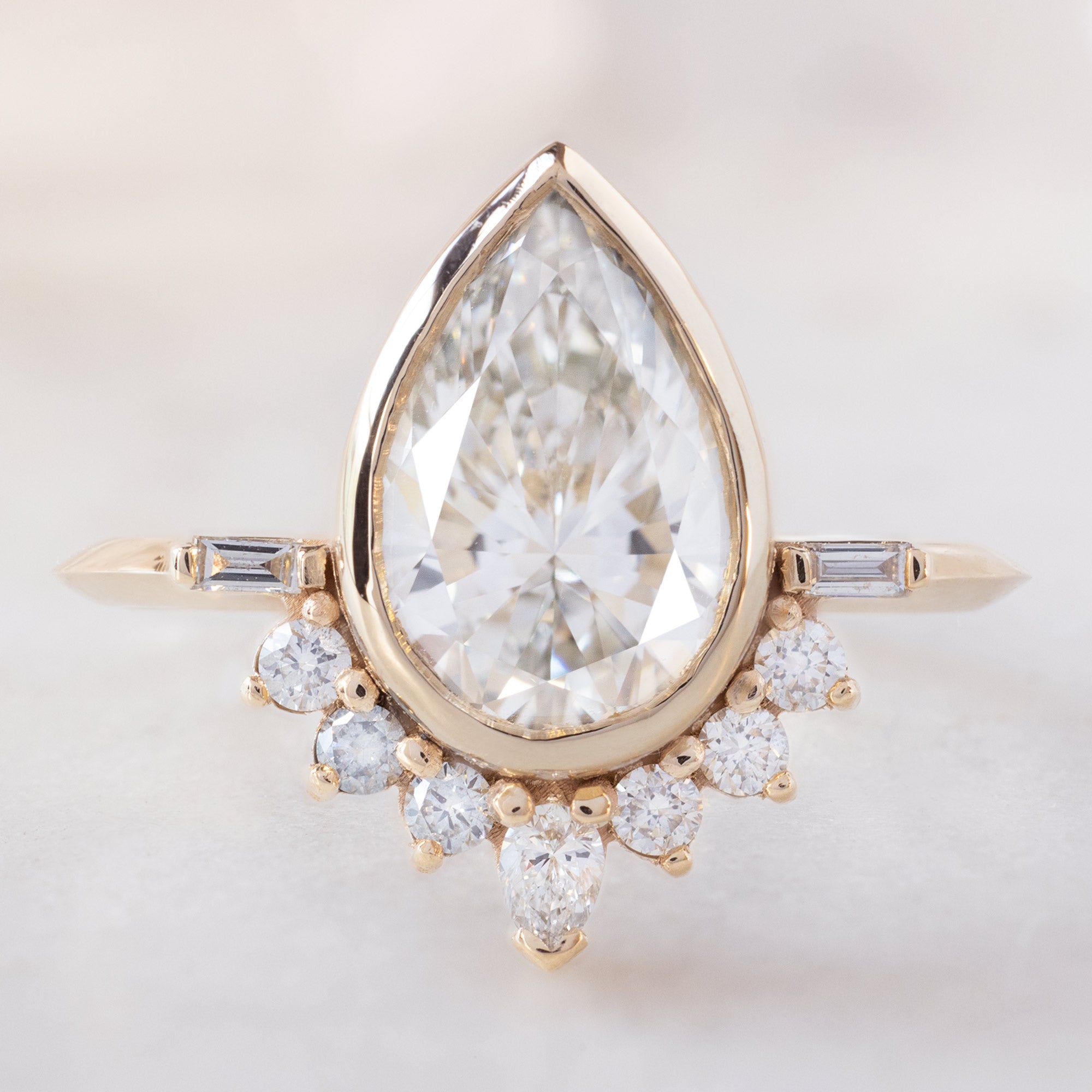 The Posy Ring with a 2.74ct Lab Grown Pear White Diamond in 14K Yellow Gold on White Marble
