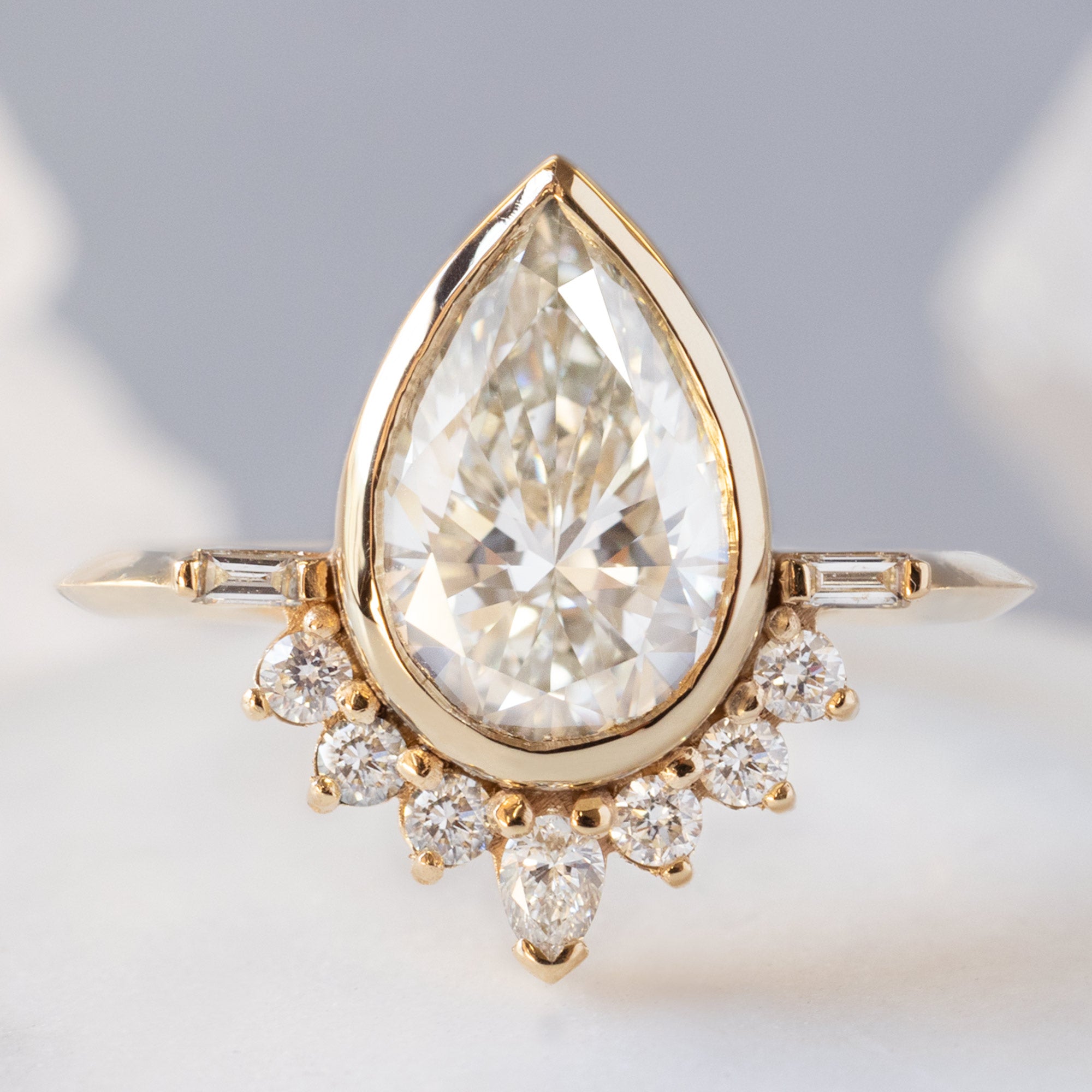 The Posy Ring with a 2.74ct Lab Grown Pear White Diamond in 14K Yellow Gold on White Marble