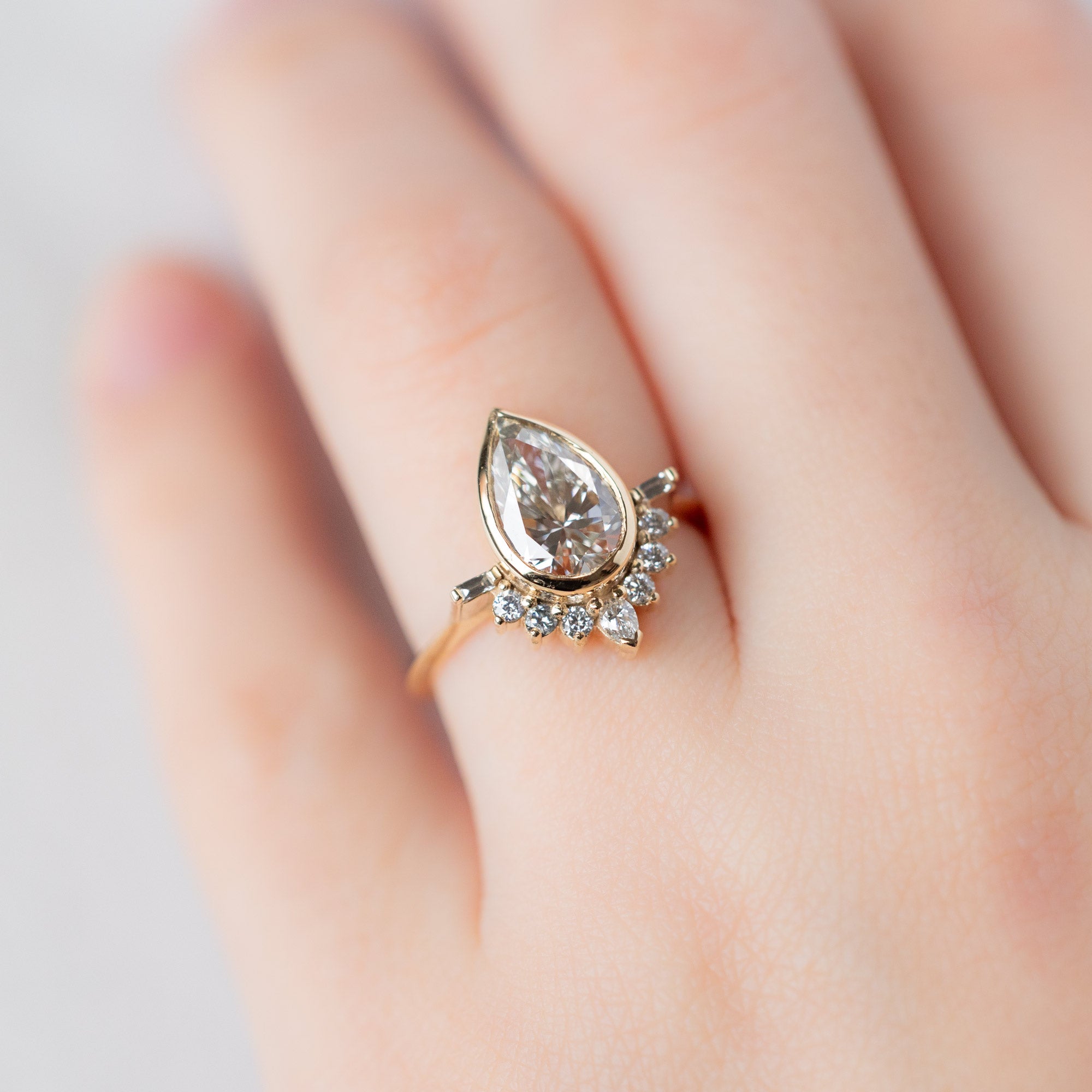 The Posy Ring with a 2.74ct Lab Grown Pear White Diamond in 14K Yellow Gold on Model