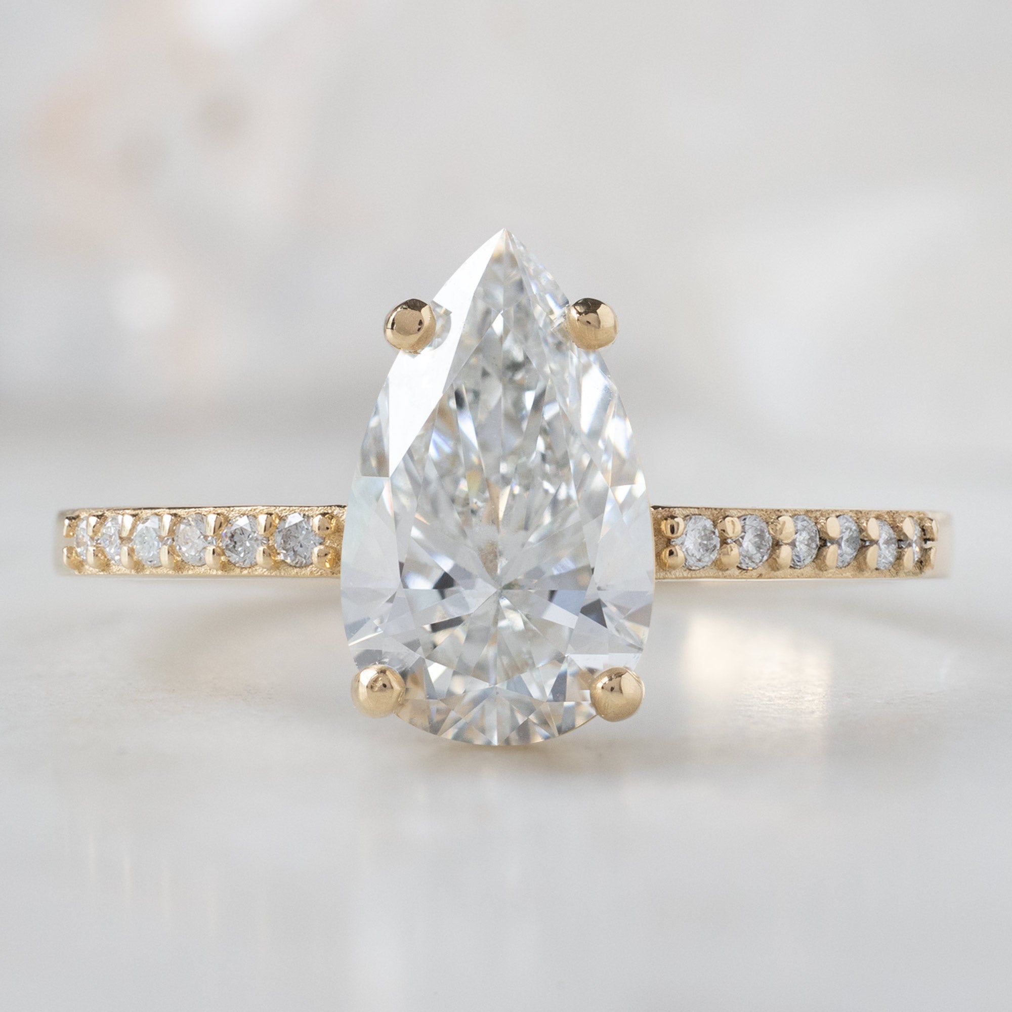 The Willow Ring with a 1.39ct Lab Grown Pear White Diamond in 14K Yellow Gold
on White Marble