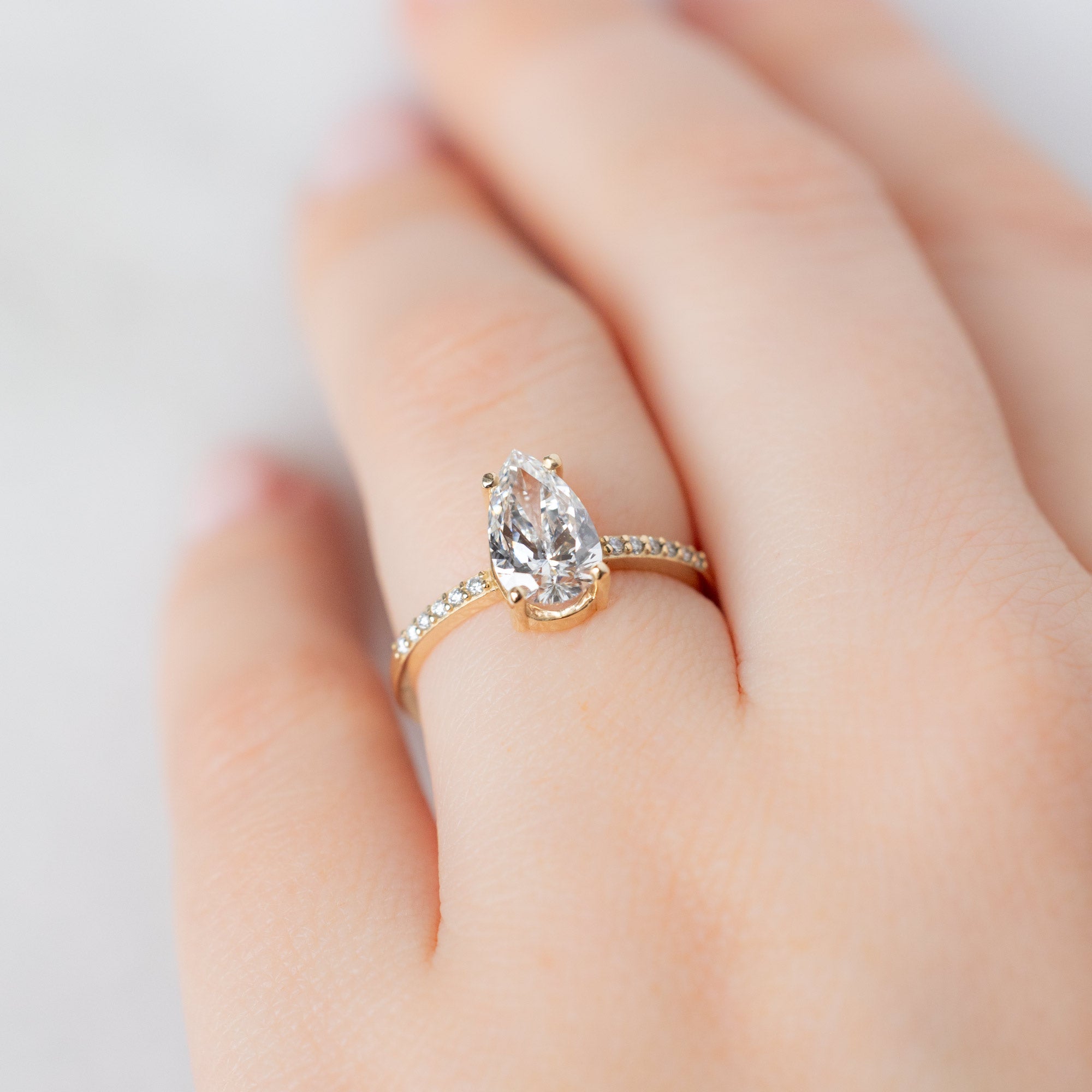 The Willow Ring with a 1.39ct Lab Grown Pear White Diamond in 14K Yellow Gold on Model