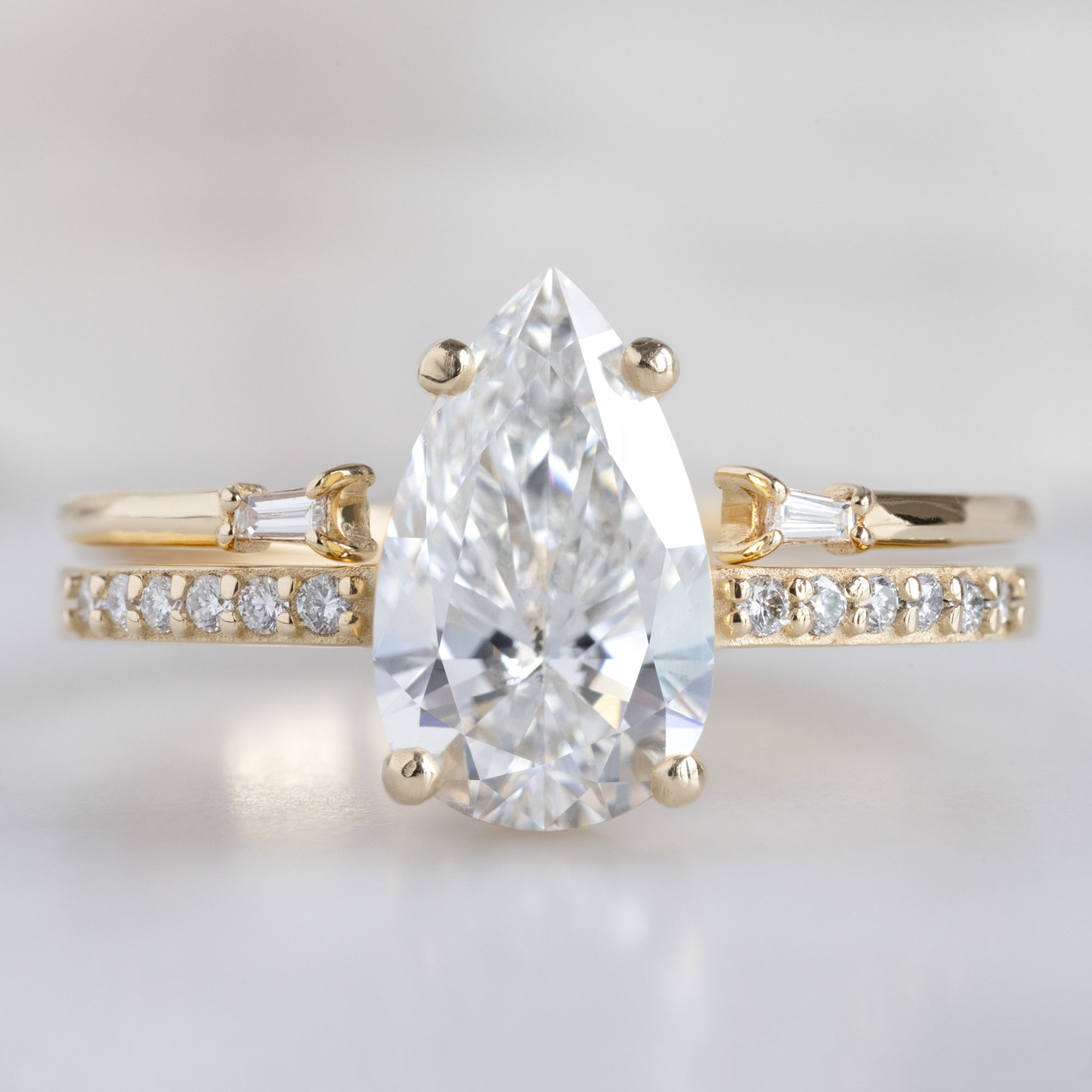 The Willow Ring with a 1.39ct Lab Grown Pear White Diamond in 14K Yellow Gold Stacked with the Open Cuff Baguette Stacking Band