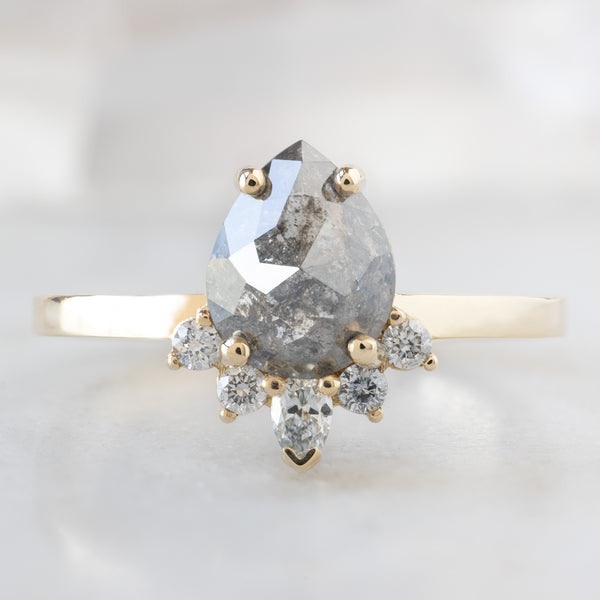 The Aster Ring with a 1.31ct Pear Salt and Pepper Diamond in 14K Yellow Gold on White Marble
