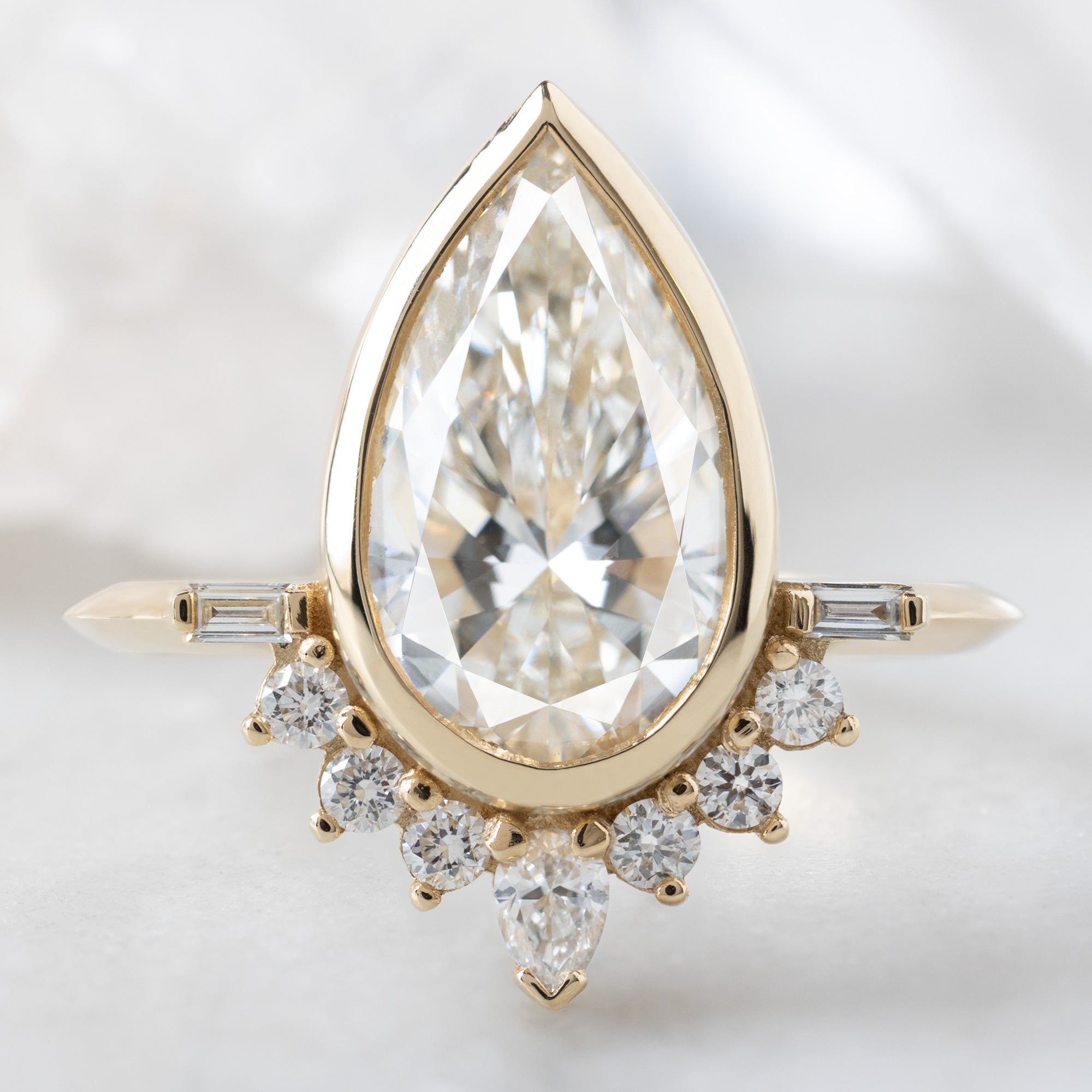 The Posy Ring with a 2.81ct Pear Lab Grown White Diamond in 14K Yellow Gold on White Marble