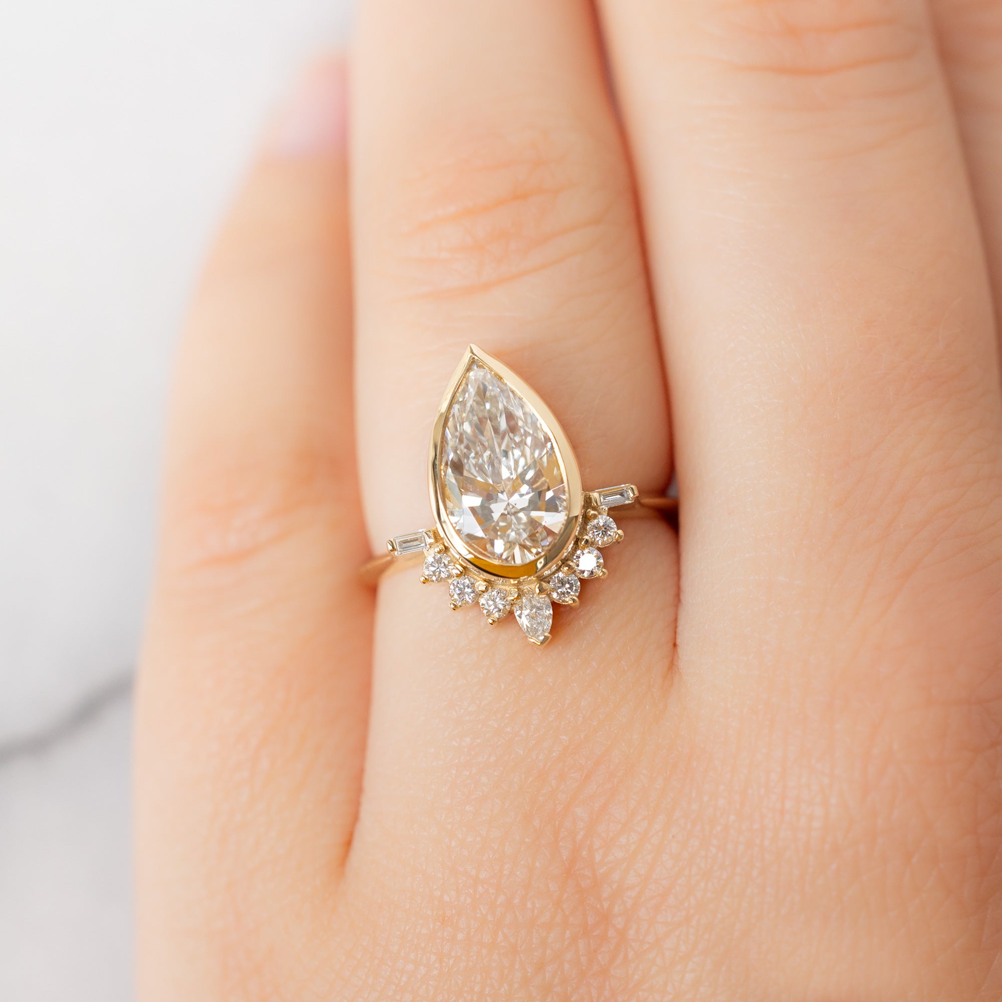 The Posy Ring with a 2.81ct Pear Lab Grown White Diamond in 14K Yellow Gold on Model