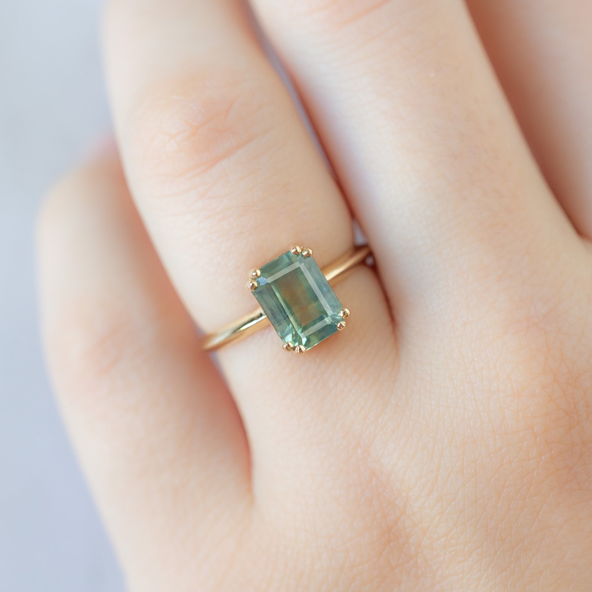 The Bryn Ring with a 2.97ct Emerald Cut Bi-Color Sapphire in 14K Yellow Gold on Model