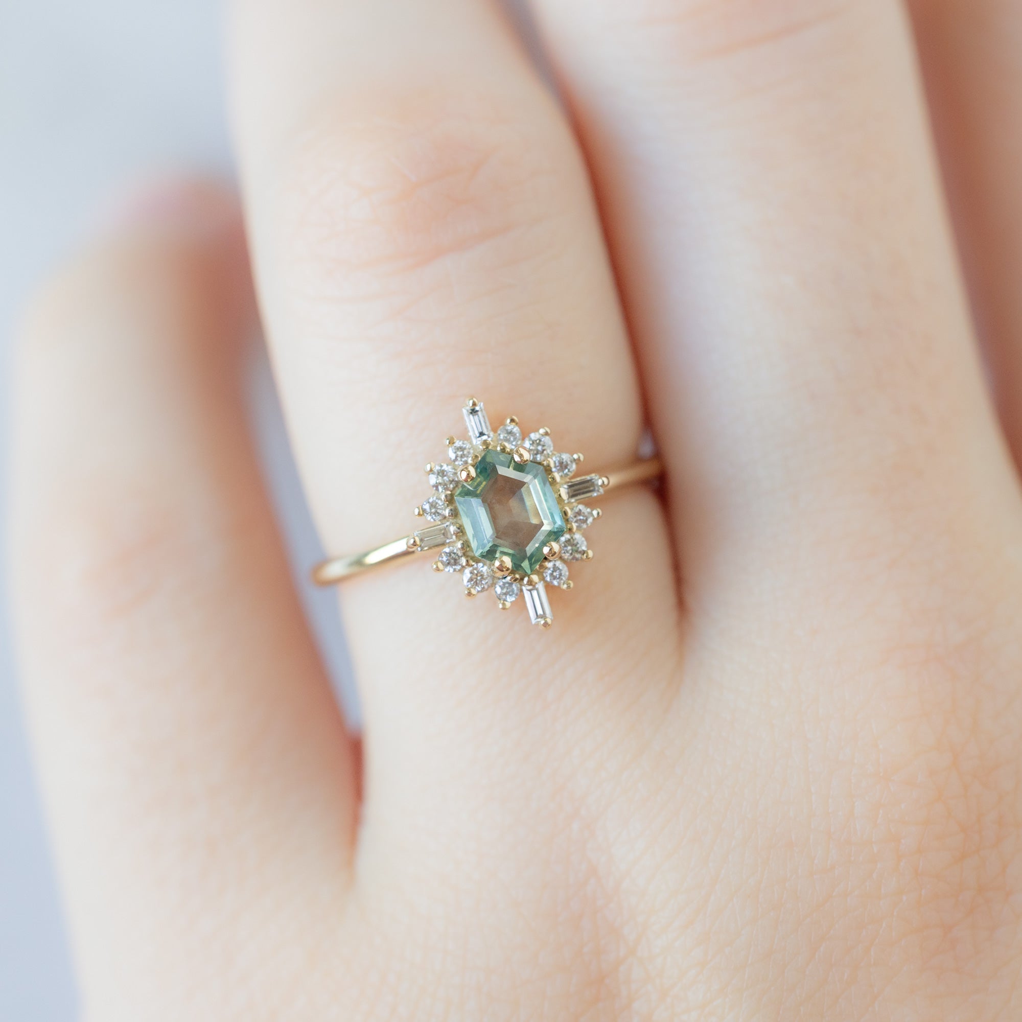 The Compass Ring with a 0.77ct Hexagon Montana Sapphire in 14K Yellow Gold on Model