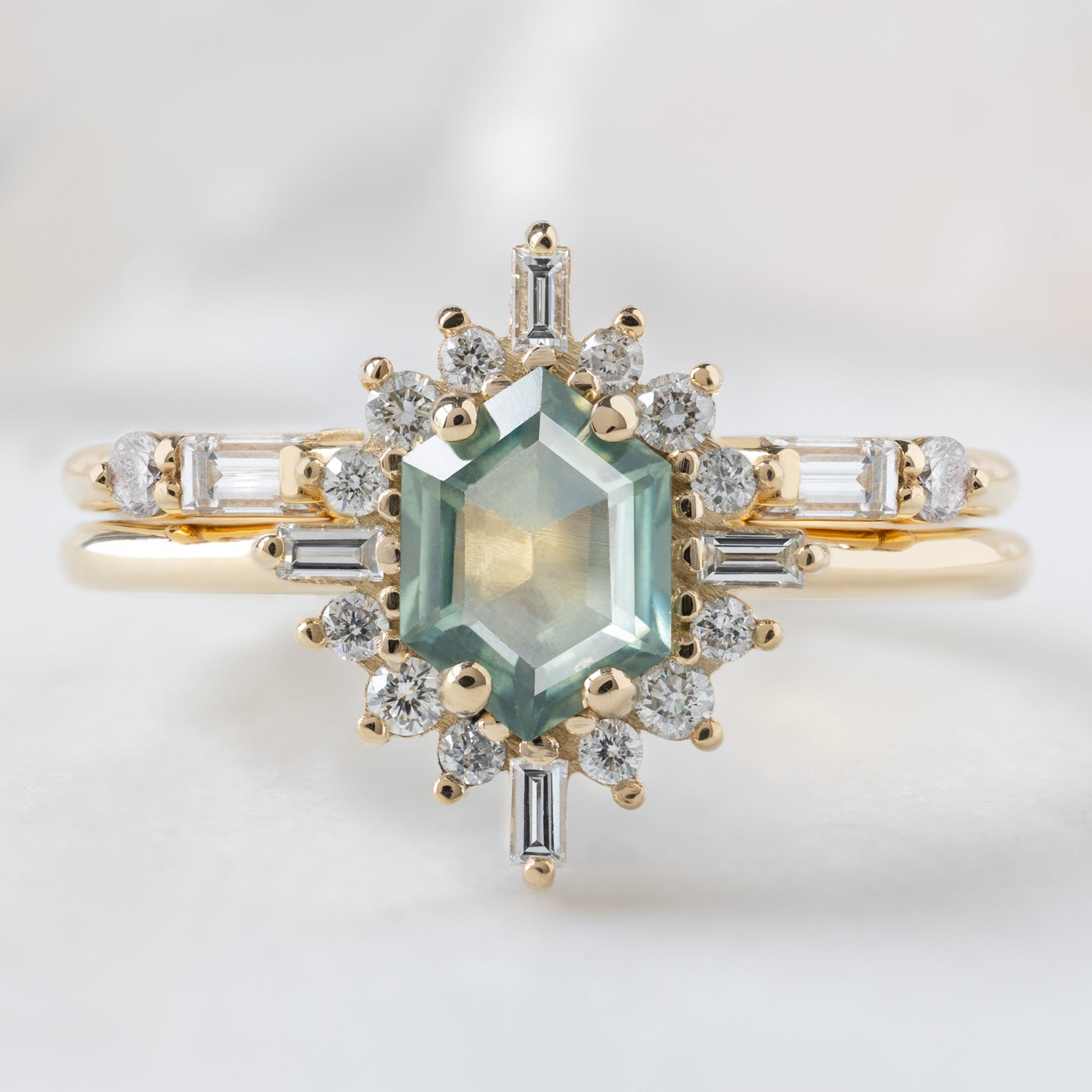 The Compass Ring with a 0.77ct Hexagon Montana Sapphire in 14K Yellow Gold Stacked with the Luxe Open Cuff White Diamond Baguette Stacking Band