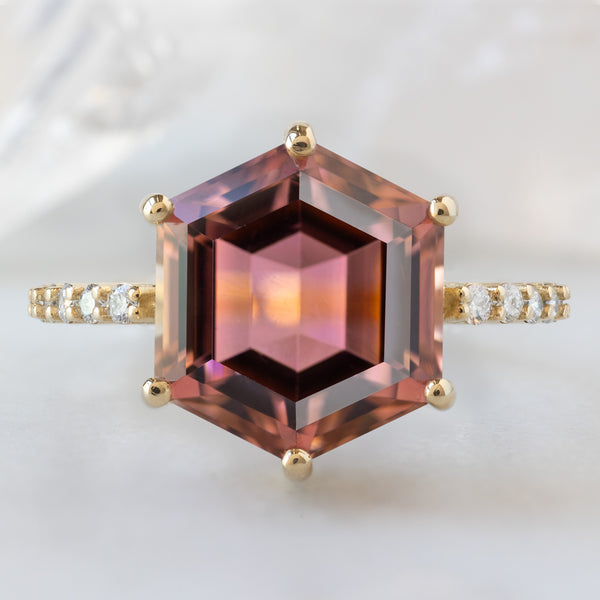 The Luxe Willow Ring with a 5.01ct Hexagon Tourmaline in 14K Yellow Gold on White Marble Surface