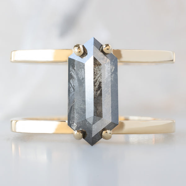 The Poppy Ring with a 1.57ct Hexagon Salt and Pepper Diamond in 14K Yellow Gold on White Marble Surface