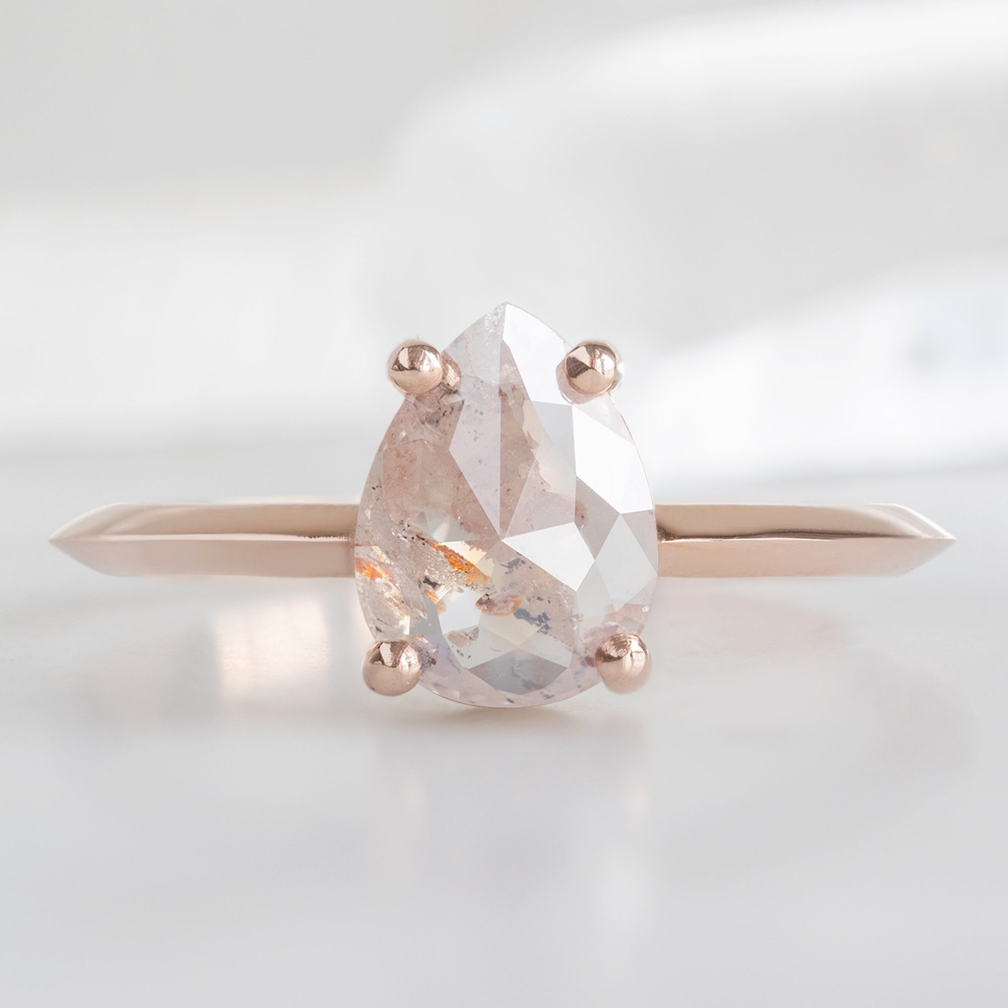 The Bryn Ring with a 1.47ct Pear Pink Diamond in 14K Rose Gold on White Marble
