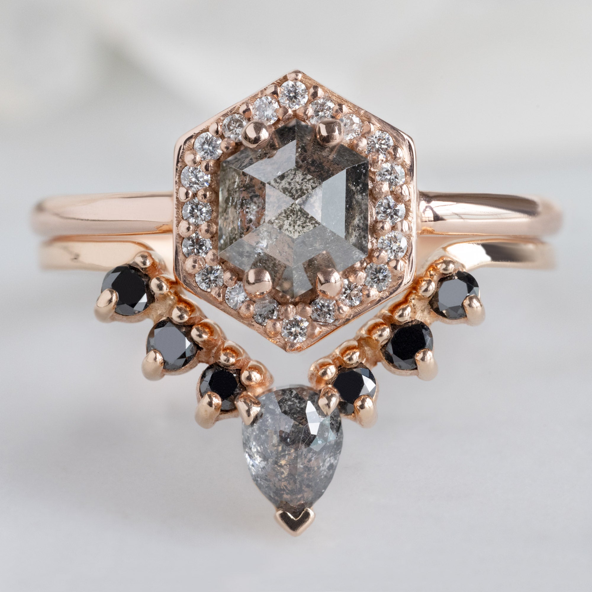 The Dahlia Ring with a 0.89ct Hexagon Salt and Pepper Diamond in 14K Rose Gold Stacked with the Black Diamond Sunburst Stacking Band