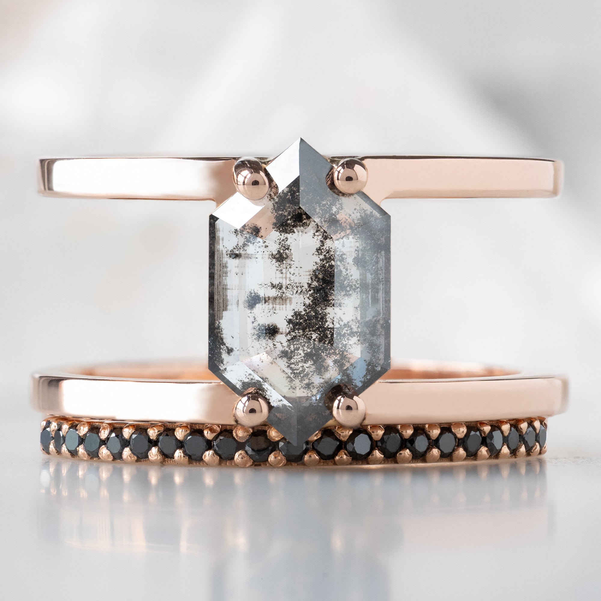 The Poppy Ring with a 1.21ct Lab Grown Salt and Pepper Hexagon in 14K Rose Gold Stacked with the Black Pavé Diamond Wedding Band