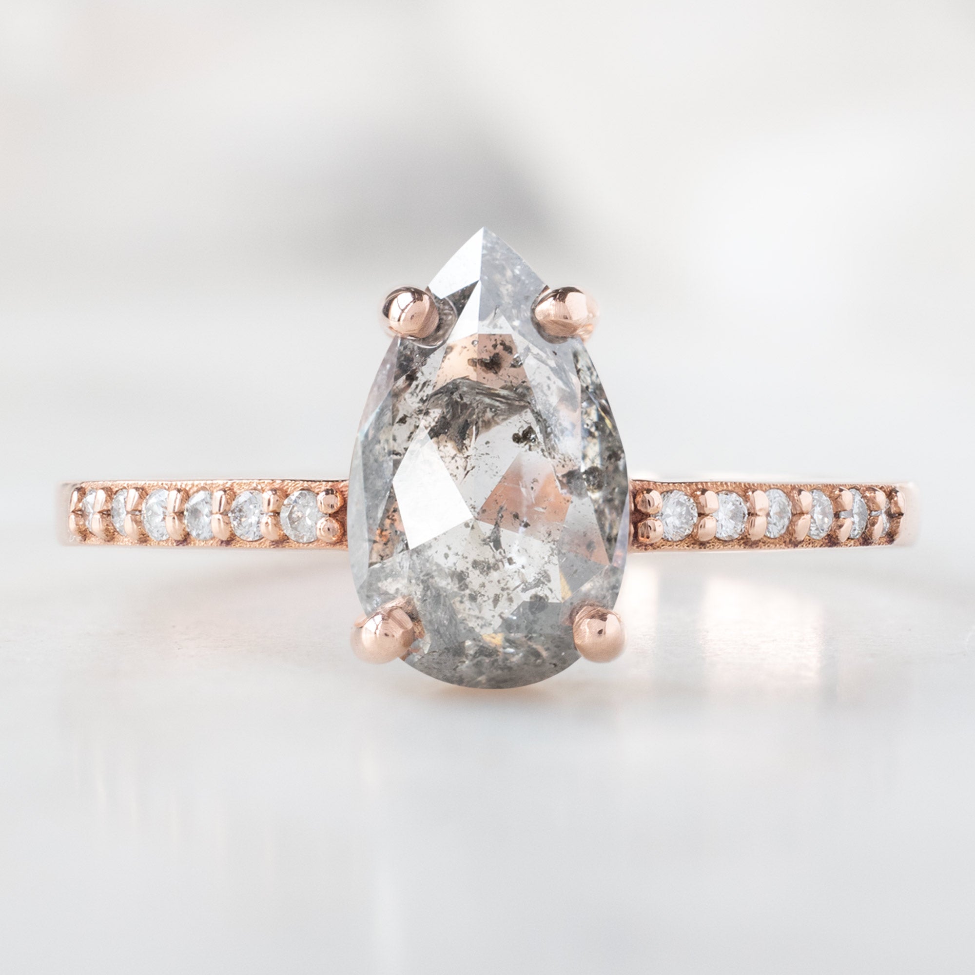 The Willow Ring with a 1.38ct Pear Salt and Pepper Diamond in 14K Rose Gold on White Marble