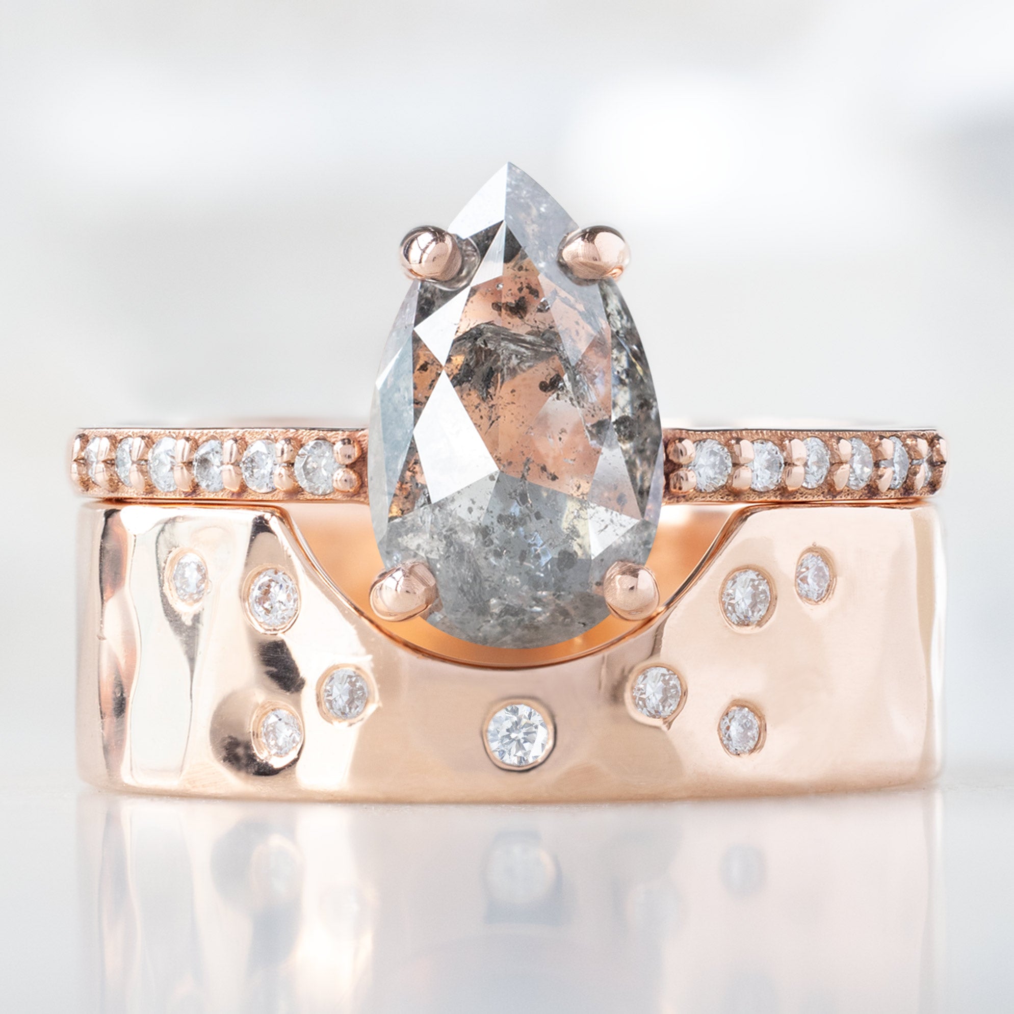 The Willow Ring with a 1.38ct Pear Salt and Pepper Diamond in 14K Rose Gold Stacked with the Constellation Cut-Out Stacking Band