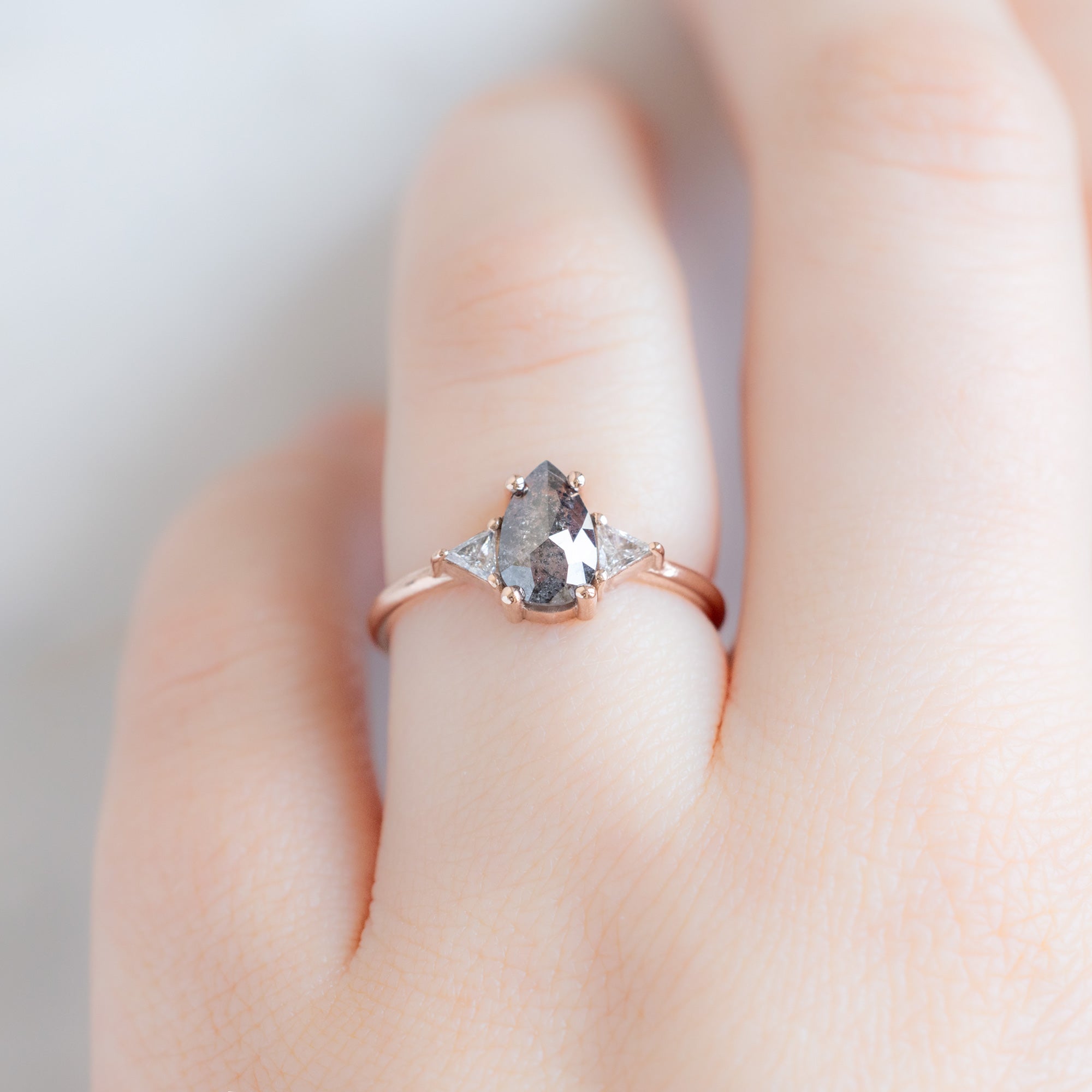 The Jade Ring with a 0.83ct Pear Salt and Pepper Diamond in 14K Rose Gold on Model
