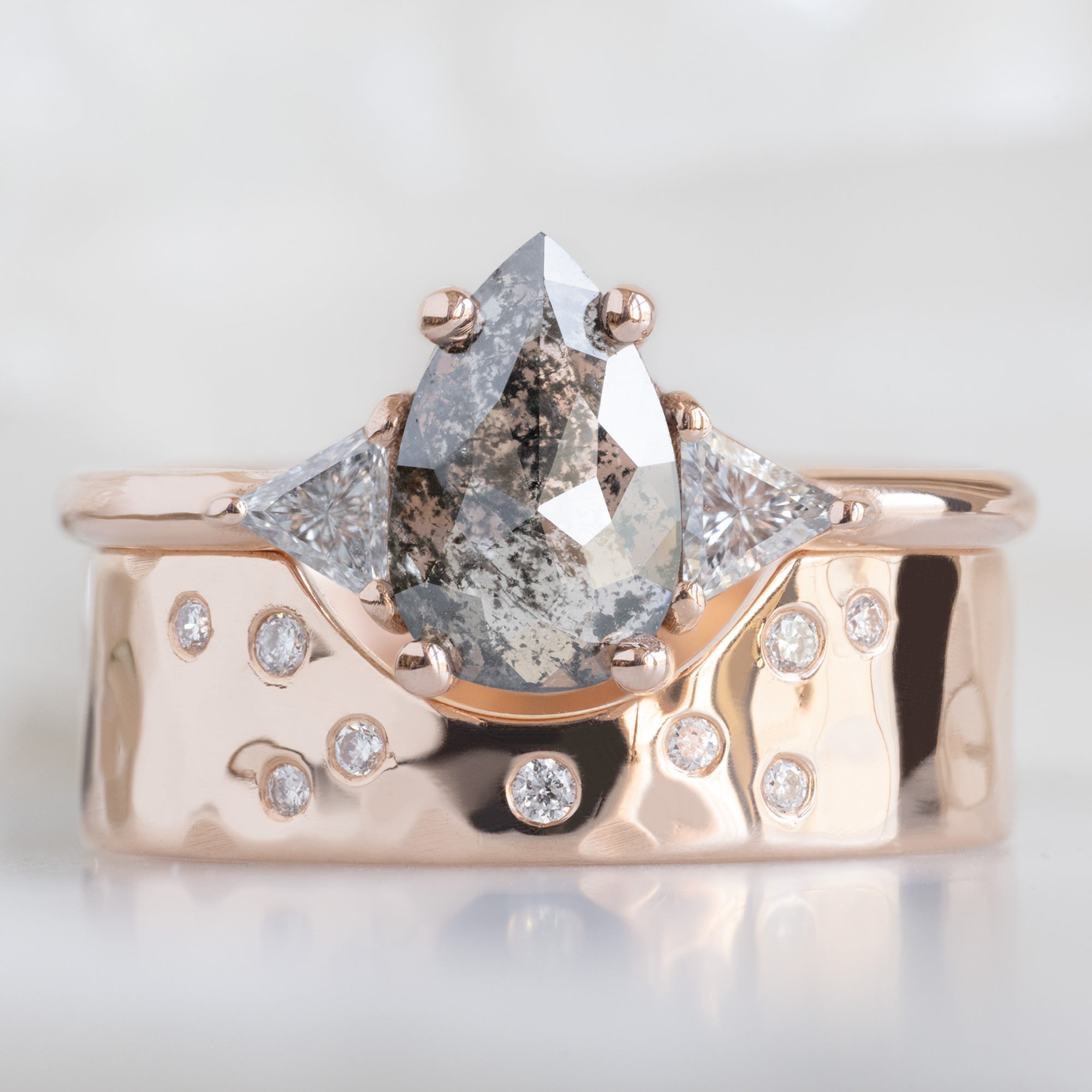 The Jade Ring with a 0.83ct Pear Salt and Pepper Diamond in 14K Rose Gold Stacked with the Constellation Arc Cut Out Stacking Band